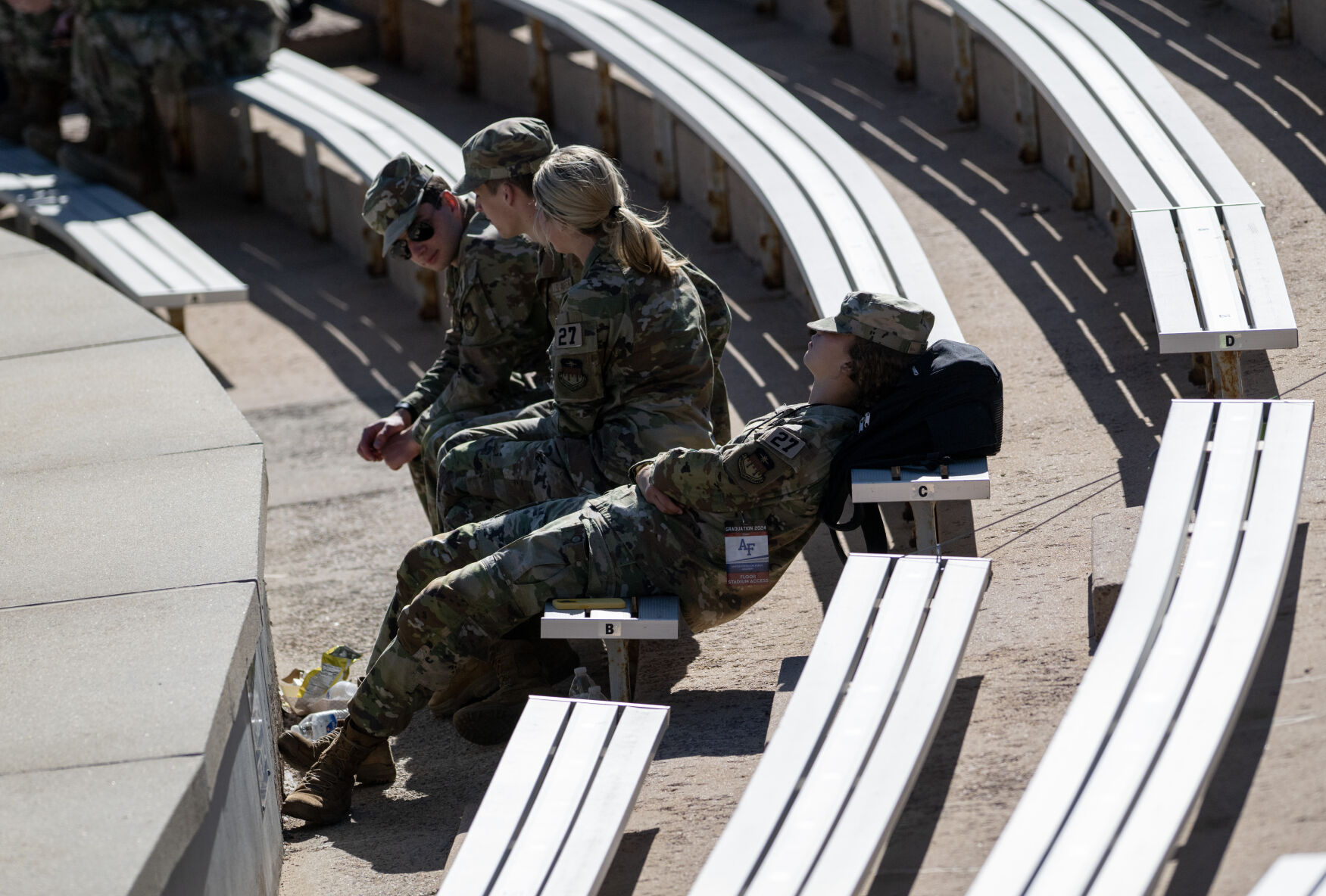 A cadet takes a snooze in the stands before the start of the United States Air Force Academy graduation at Falcon Stadium on Thursday, May 30, 2024, in Colorado Springs, Colo. (Parker Seibold, The Gazette) (Parker Seibold)