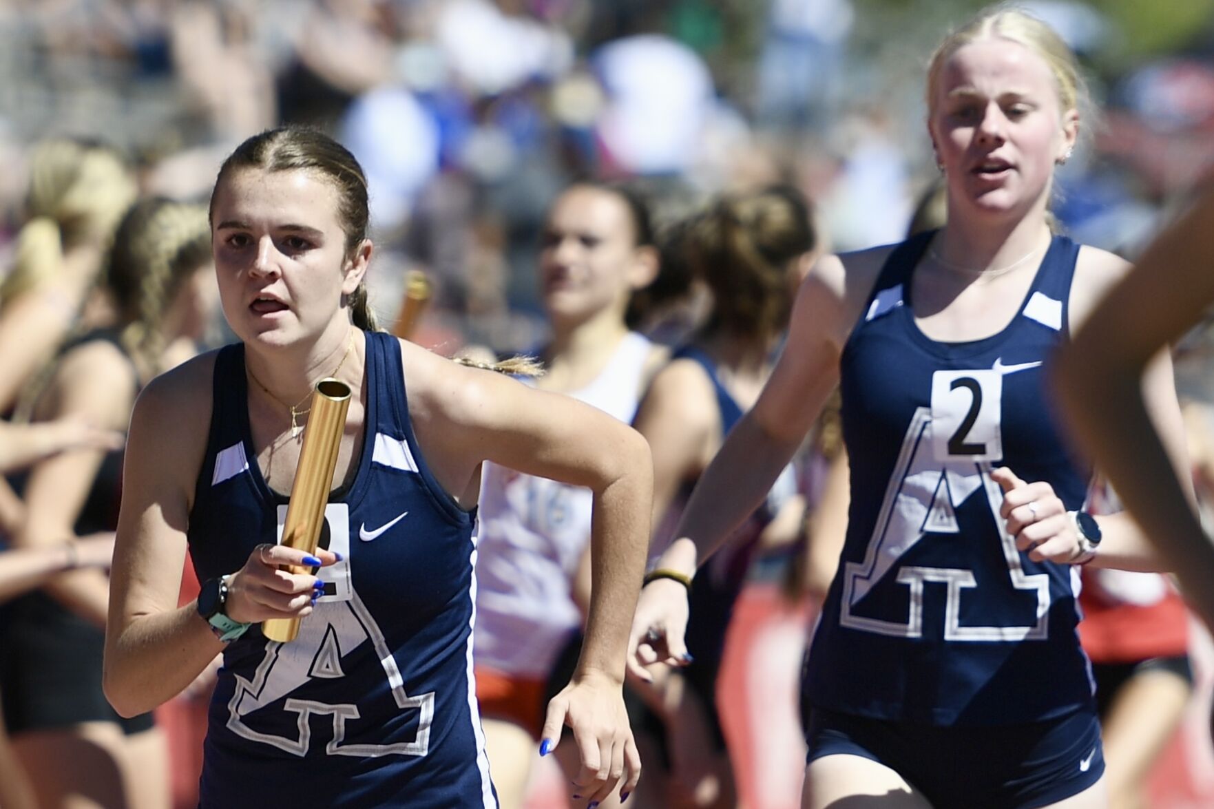 Air Academy’s Bethany Michalak receives the baton from Tessa Walter in the 4x800 at the state track and field championships Thursday. (CarsonFieldcarson.field@gazette.comhttps://secure.gravatar.com/avatar/c524ef3d384945349bed78d70eb2d2cd?d=mm&r=g)