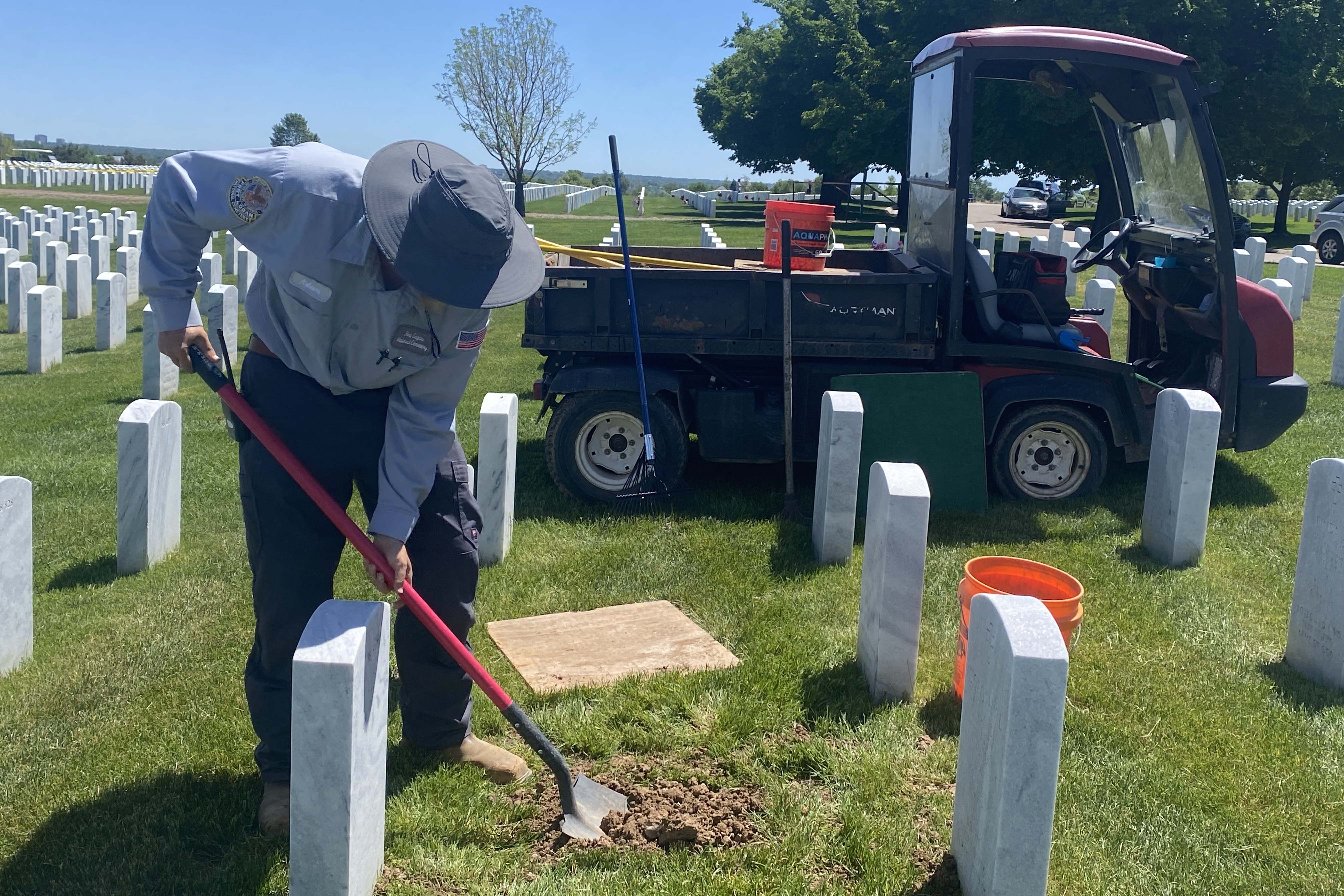 Ft. Logan Internment Specialist Adam Buejler buries Don Eckart at the start of Memorial Day weekend.