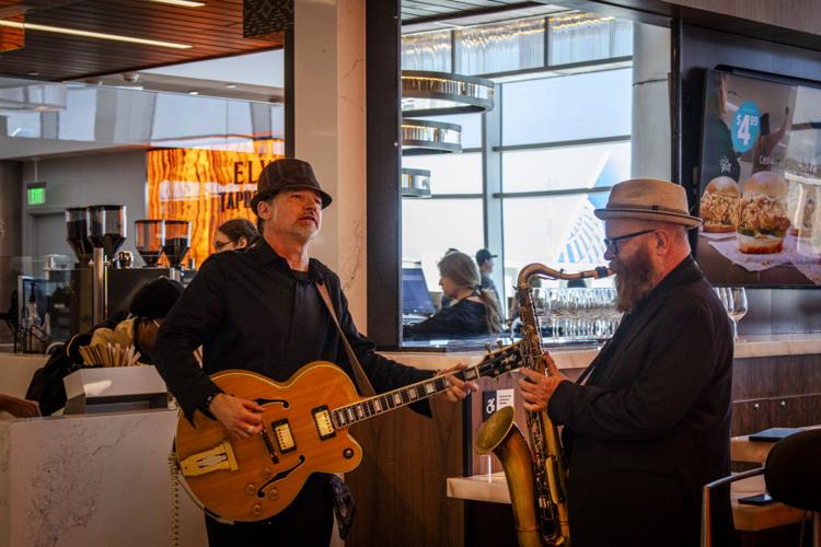 Musicians playing at DIA concourse concession grand opening