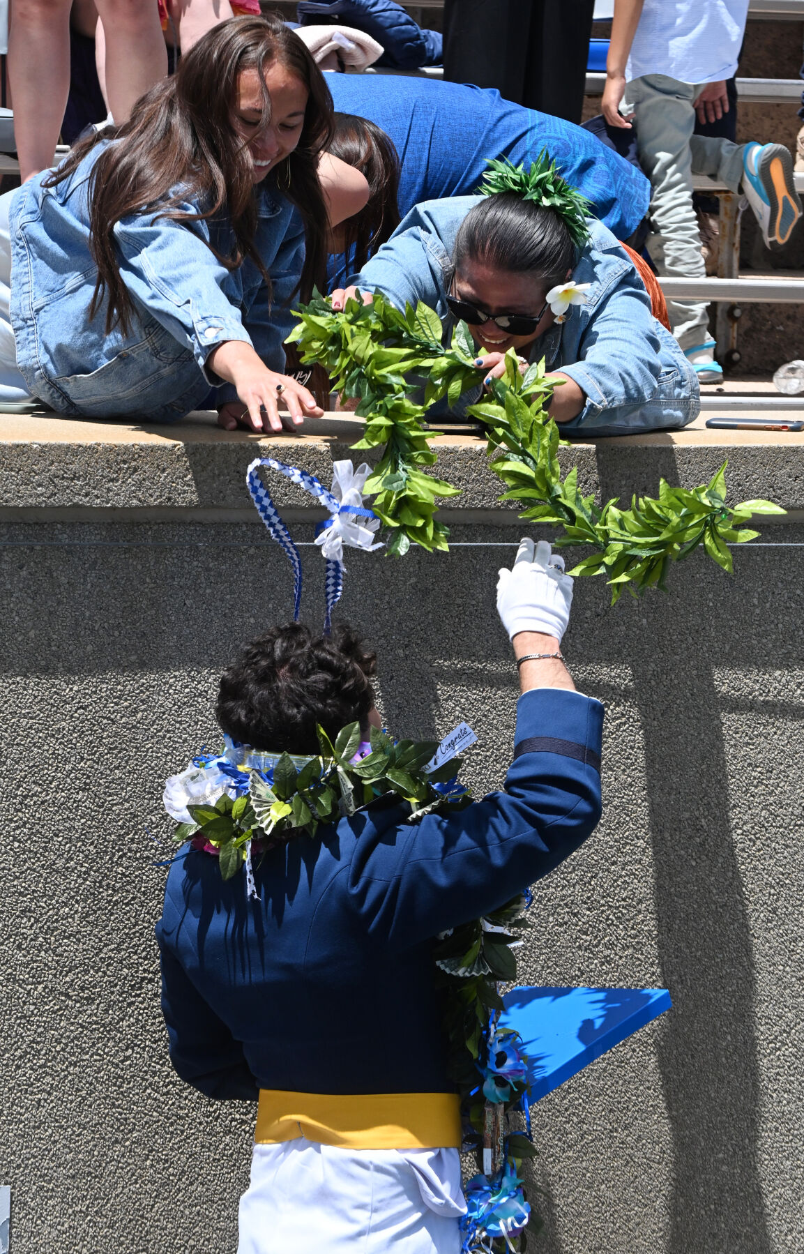 Cadet Glenn McGaughey gets leis from his Samoan family after the Graduation Ceremony at Falcon Stadium at the Air Force Academy on Thursday, May 30, 2024. (Photo by Jerilee Bennett, The Gazette)