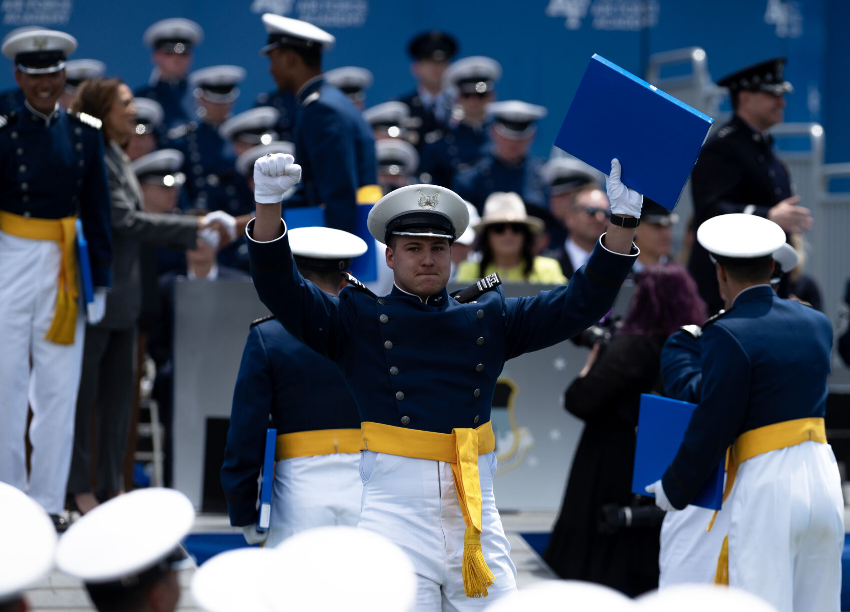 A graduate holds up their diploma as they walk back to their seat during the United States Air Force Academy graduation at Falcon Stadium on Thursday, May 30, 2024, in Colorado Springs, Colo. (Parker Seibold, The Gazette) (Parker Seibold)