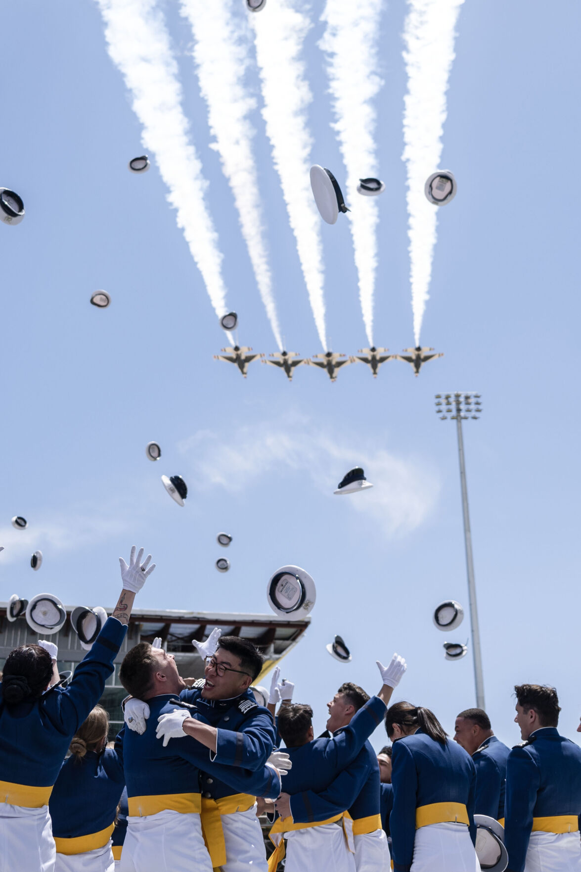 Air Force graduates celebrate as the Thunderbirds fly over Falcon Stadium at the conclusion of the Air Force Academy Graduation on Thursday, May 30, 2024. (Stephen Swofford, The Gazette) (Stephen Swofford The Gazette)