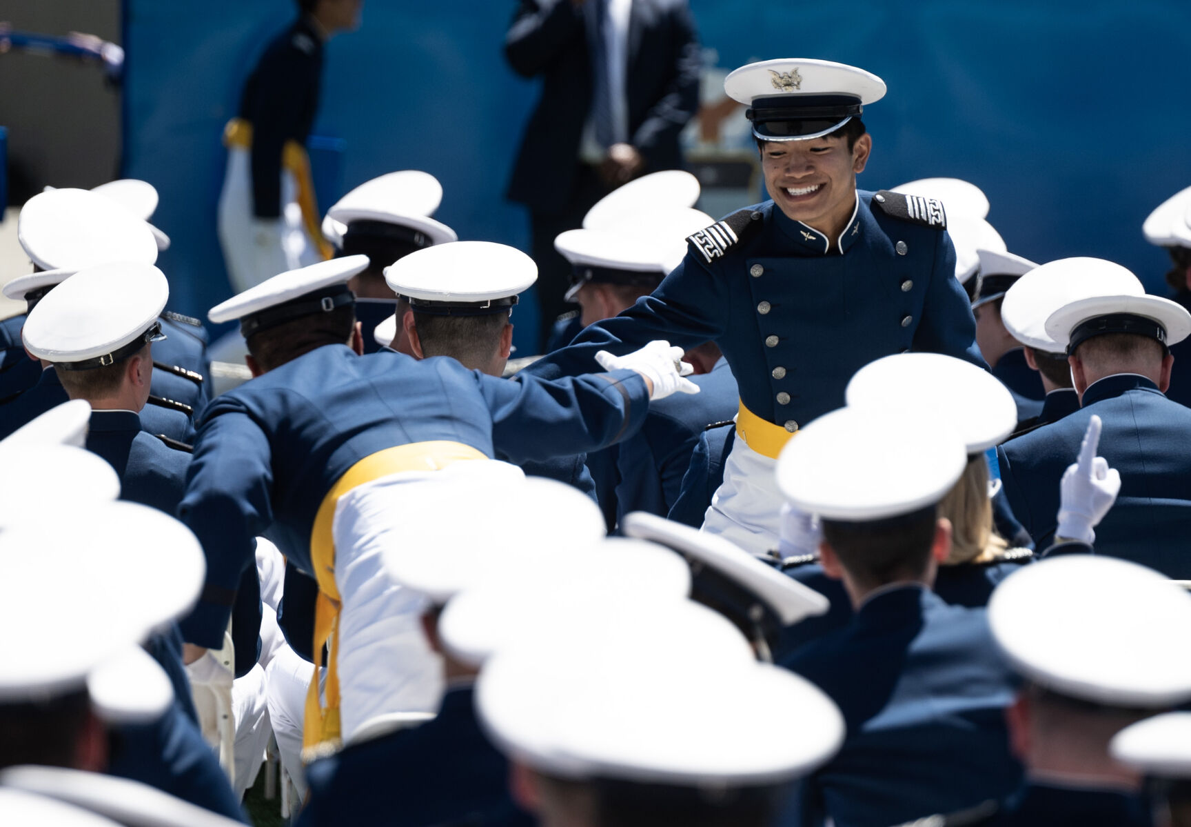 Graduates high-five during the United States Air Force Academy graduation at Falcon Stadium on Thursday, May 30, 2024, in Colorado Springs, Colo. (Parker Seibold, The Gazette) (Parker Seibold)