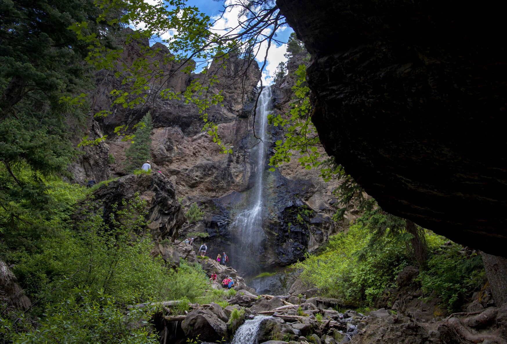 Hikers explore Treasure Falls on the westside of Wolf Creek Pass near Pagosa Springs, Colo., Monday, June 22, 2020. The 105-foot waterfall is a short hike, 1/4 mile, from the parking lot along U.S. Highway 160 and makes for a quick break for motorists traveling through Southern Colorado. (The Gazette, Christian Murdock) (CHRISTIAN MURDOCK/THE GAZETTE)