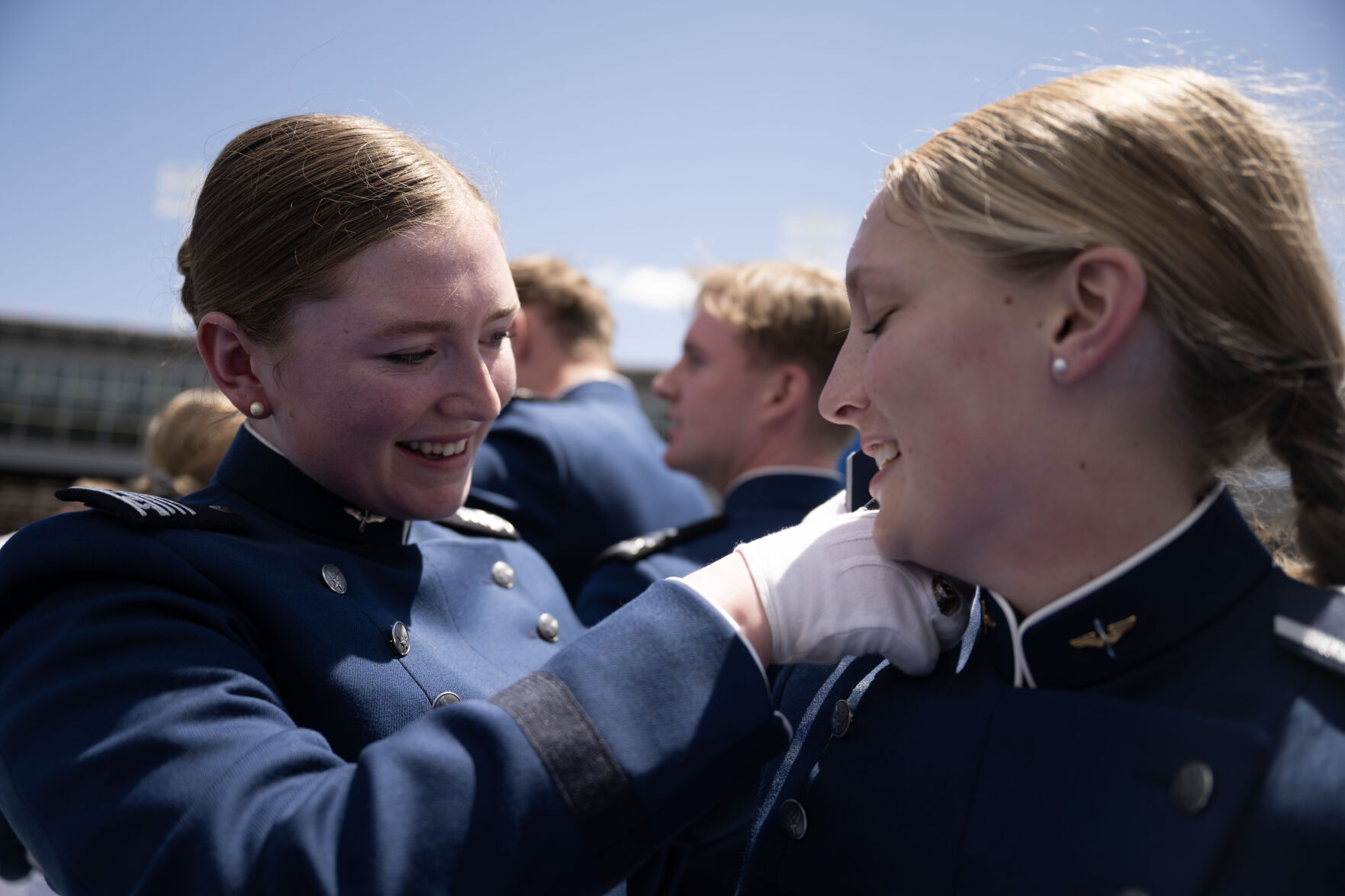 Kennedy Greco, left, changes the epaulettes on Maiya Woelbling’s uniform at the conclusion of the Air Force Academy Graduation on Thursday, May 30, 2024. (Stephen Swofford,The Gazette) (Stephen Swofford The Gazette)