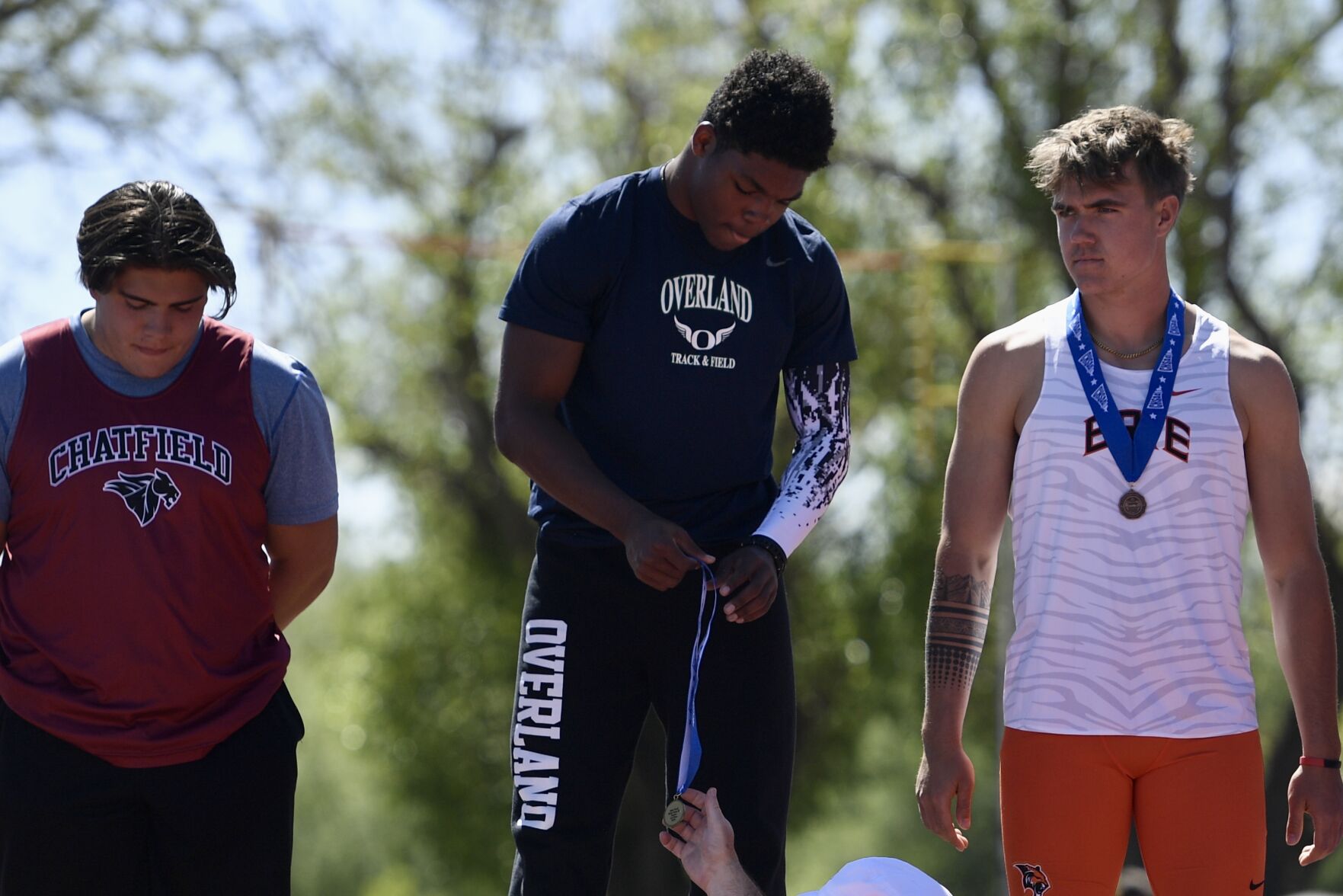 Overland's Jarrius Ward receives a gold medal in the 5A shot put at the CHSAA state track and field championships on Thursday, May 16, 2024. (CarsonFieldcarson.field@gazette.comhttps://secure.gravatar.com/avatar/c524ef3d384945349bed78d70eb2d2cd?d=mm&r=g)