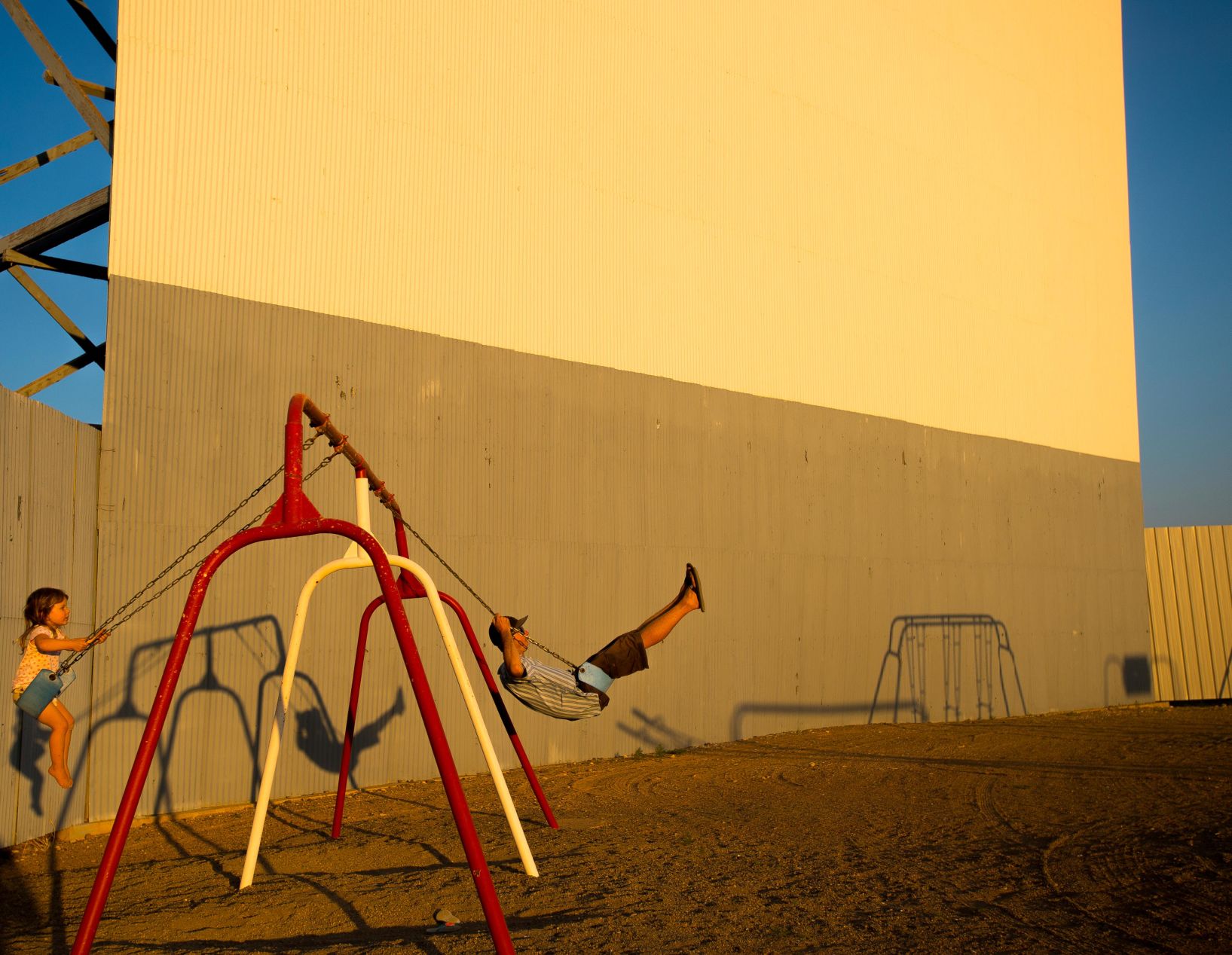 Jemma Soderberg, 3, and her farther Matt Soderberg both of Boulder, Colorado enjoy the swing-set during sunset before the start of them watching 'Captain Underpants' at the Best Western Movie Manor and Star Drive-in on Wednesday June 21, 2017 in Monte Vista, Colorado. (Photo by Dougal Brownlie, The Gazette). (DOUGAL BROWNLIE)