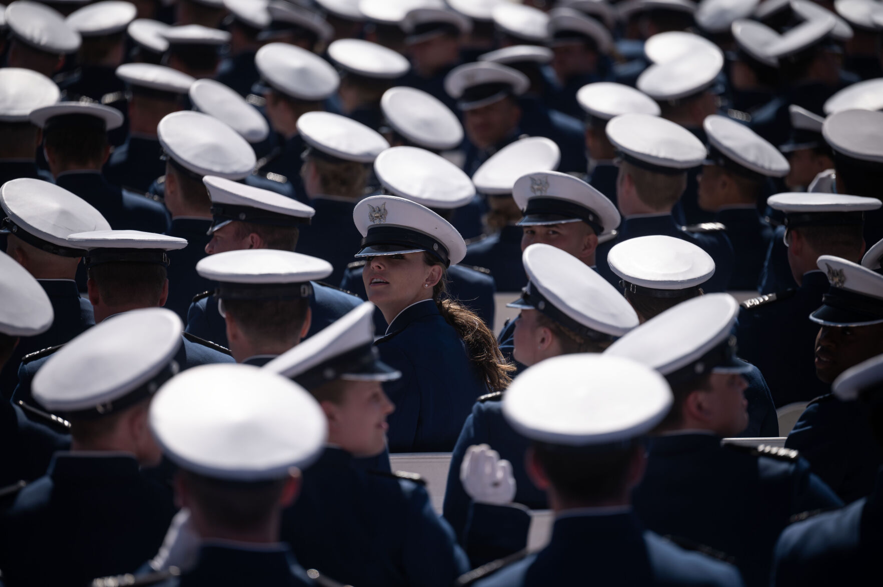 An Air Force graduate looks for her family in the stands during the Air Force Academy Graduation on Thursday, May 30, 2024. (Stephen Swofford, The Gazette) (Stephen Swofford The Gazette)