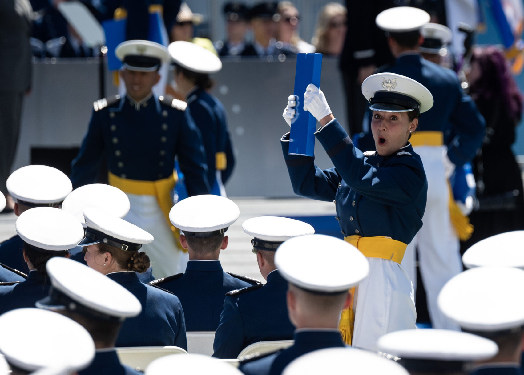 A graduate holds up their diploma as they make their way back to their seat during the United States Air Force Academy graduation at Falcon Stadium on Thursday, May 30, 2024, in Colorado Springs, Colo. (Parker Seibold, The Gazette) (Parker Seibold)