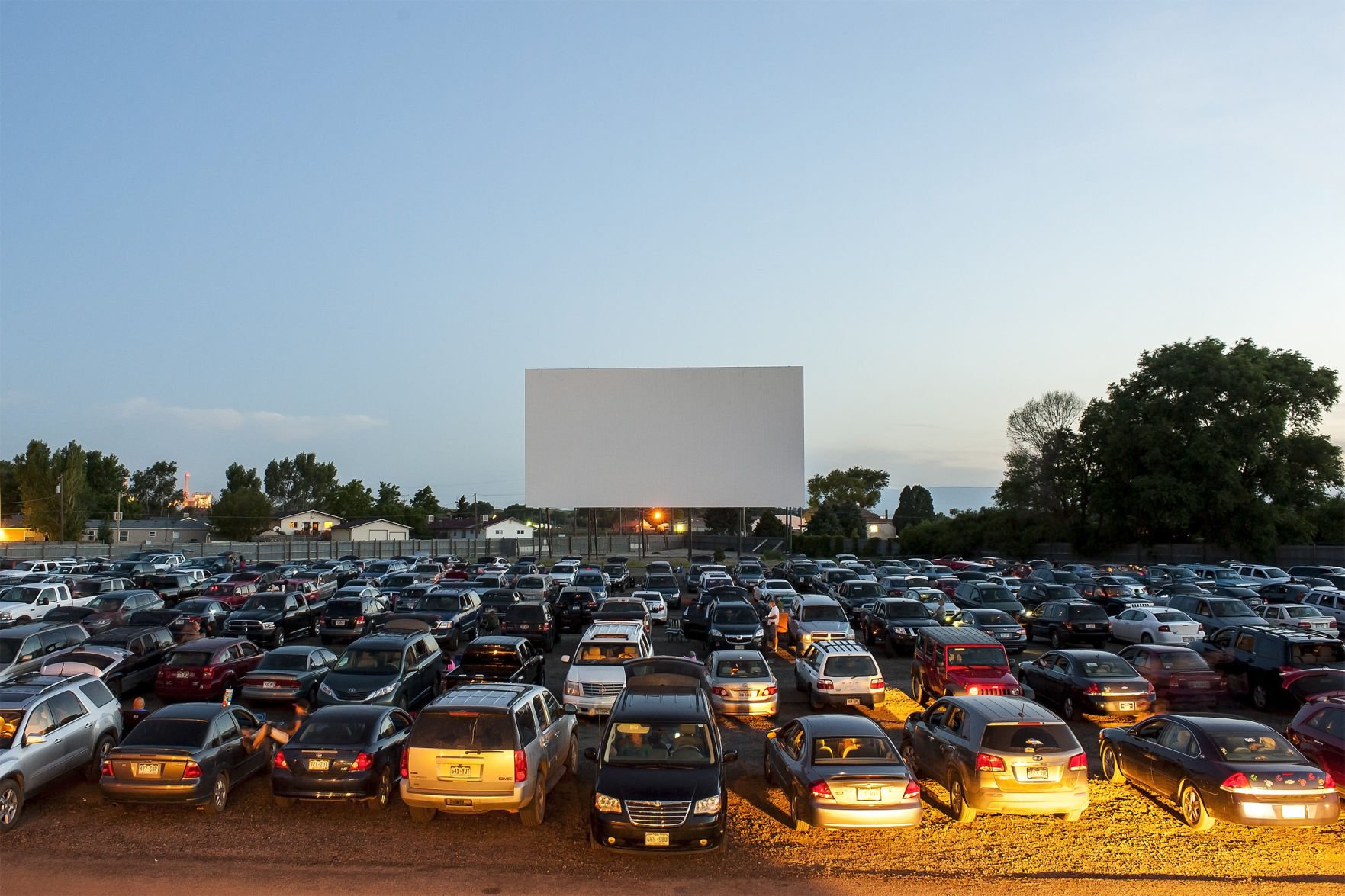 Families and friends wait for their movie to start at the Mesa Drive-In in Pueblo, Colorado, on June 20, 2015. As new screens open in Denver this month, the number of drive-in movie theaters are dwindling. Those that survive, thrive on nostalgia. Photo by Logan Riely, The Gazette (LOGAN RIELY)