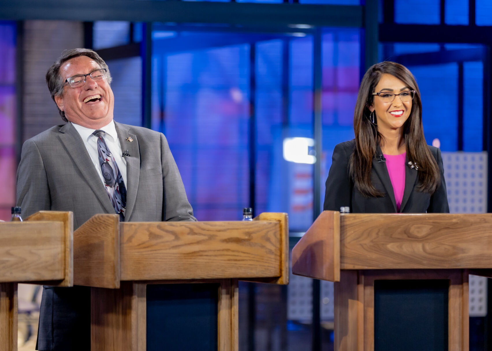 Jerry Sonnenberg laughs along with U.S. Rep. Lauren Boebert during the May 30 Republican candidate debate hosted by 9News and Colorado Politics. (Tom Green, 9News)