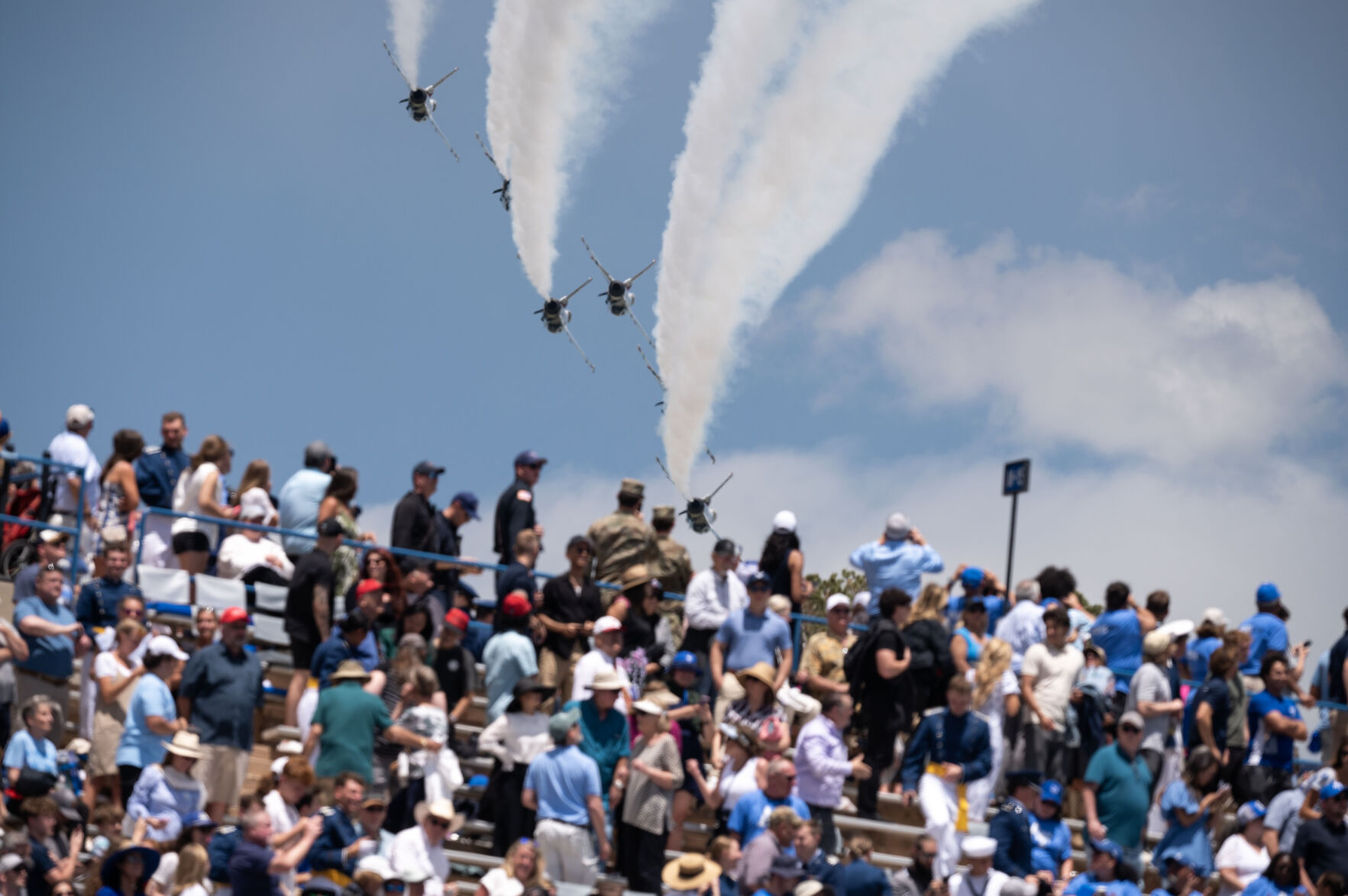 Audience members watch the Thunderbirds as they fly past Falcon Stadium during the Air Force Academy Graduation on Thursday, May 30, 2024. (Stephen Swofford, The Gazette) (Stephen Swofford The Gazette)