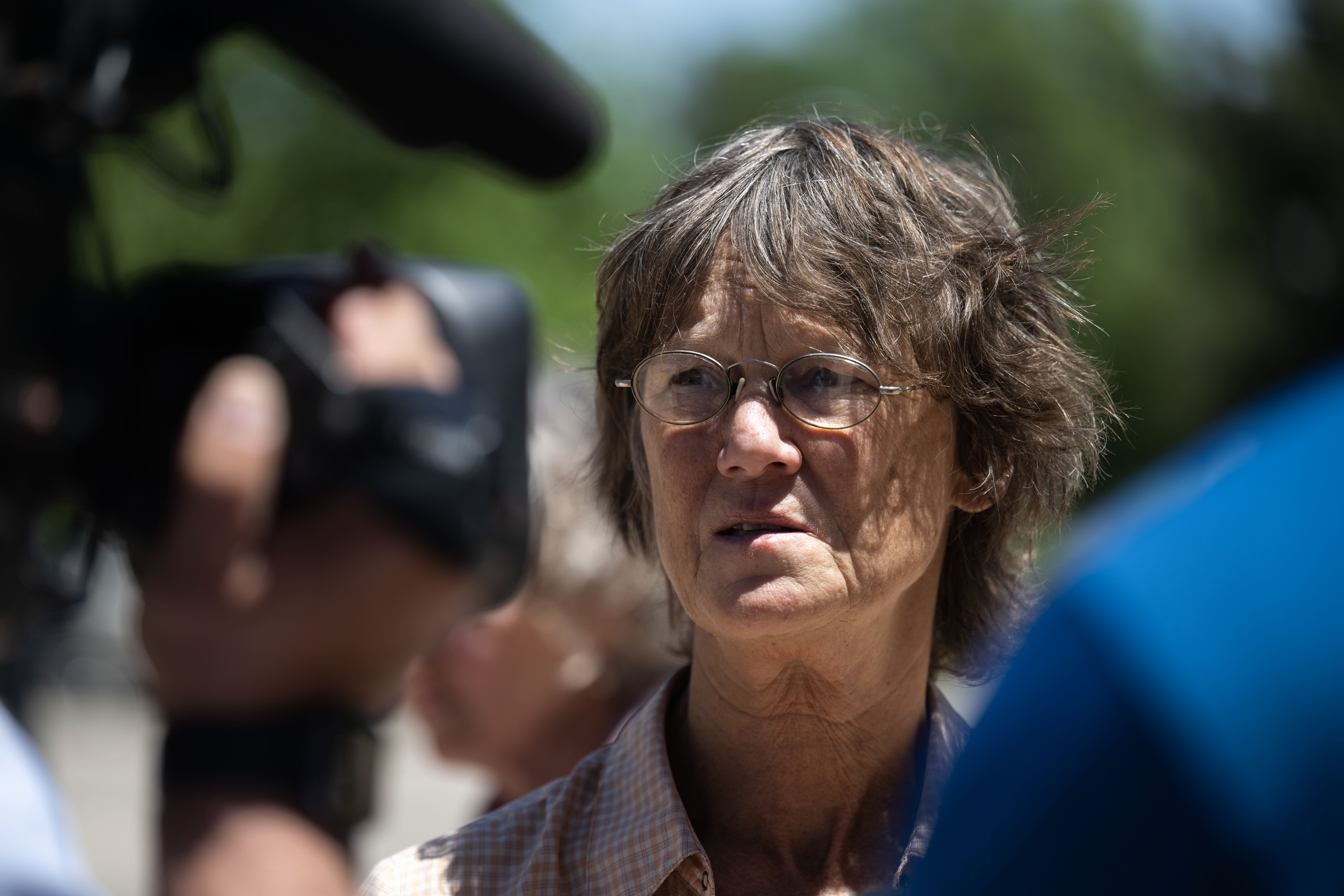 Julie Smith, Sister of Kelly Sloat-White, talks with reporters outside the courthouse after Garrett Coughlin pleaded guilty to second-degree murder for a triple homicide. Coughlin was sentenced to 42 years with the possibility of parole after 24 years. (Stephen Swofford, The Gazette)
