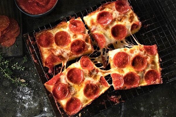 Jet's Pizza serves up square, Detroit-style pizza; the chain, which has four Denver-area locations, opened its first Colorado Springs outlet in mid-May on the city's northeast side and plans a grand opening Saturday. COURTESY JET'S PIZZA