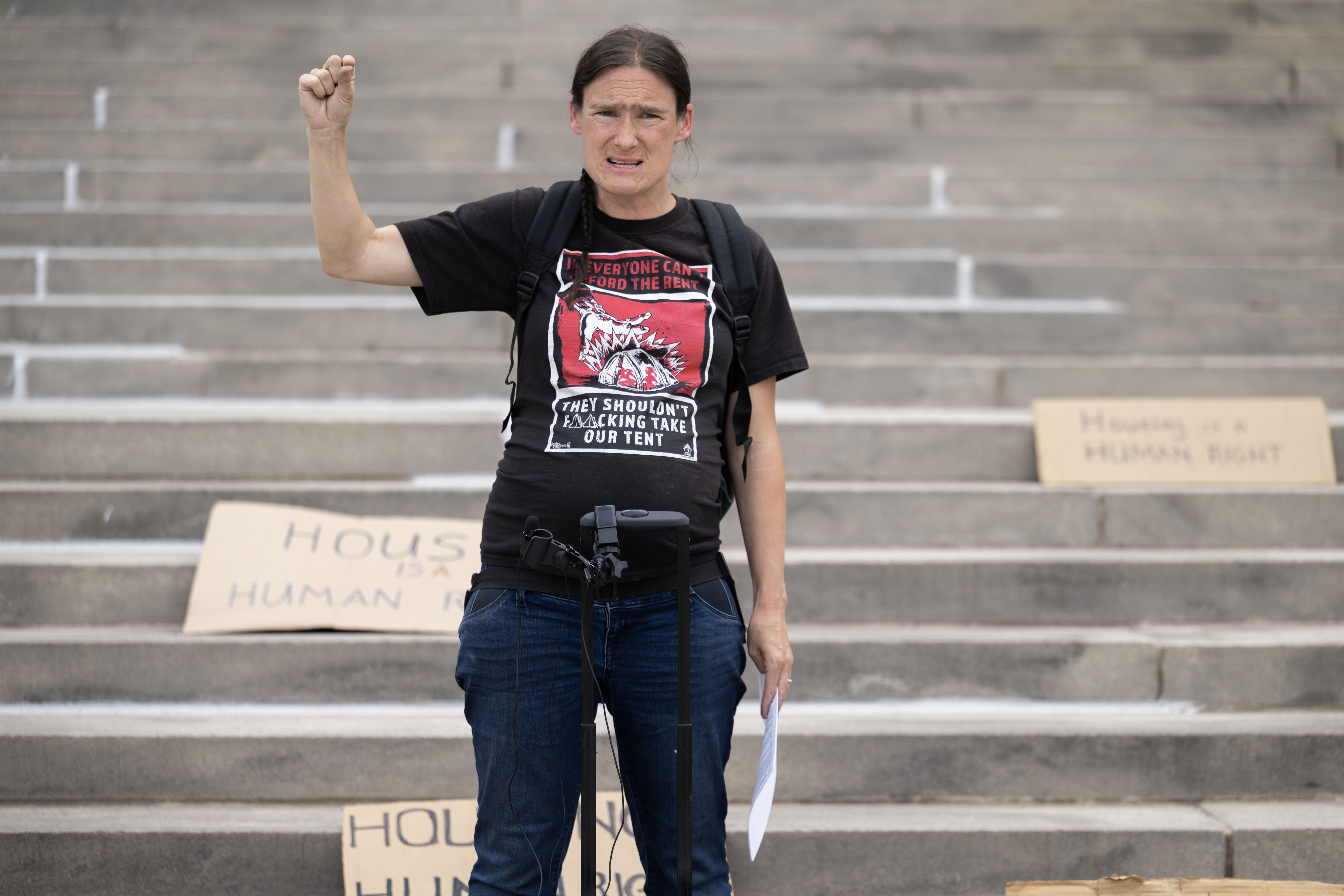 Terese Howard, leader of the Housekeys Action Network Denver, presents statistics of police records showing an increase in anti-houseless law enforcement in Denver from January to March of 2024 during a protest on the steps of the Denver City and County Building on Monday, June 3, 2024. (Stephen Swofford, Denver Gazette) (Stephen Swofford The Gazette)