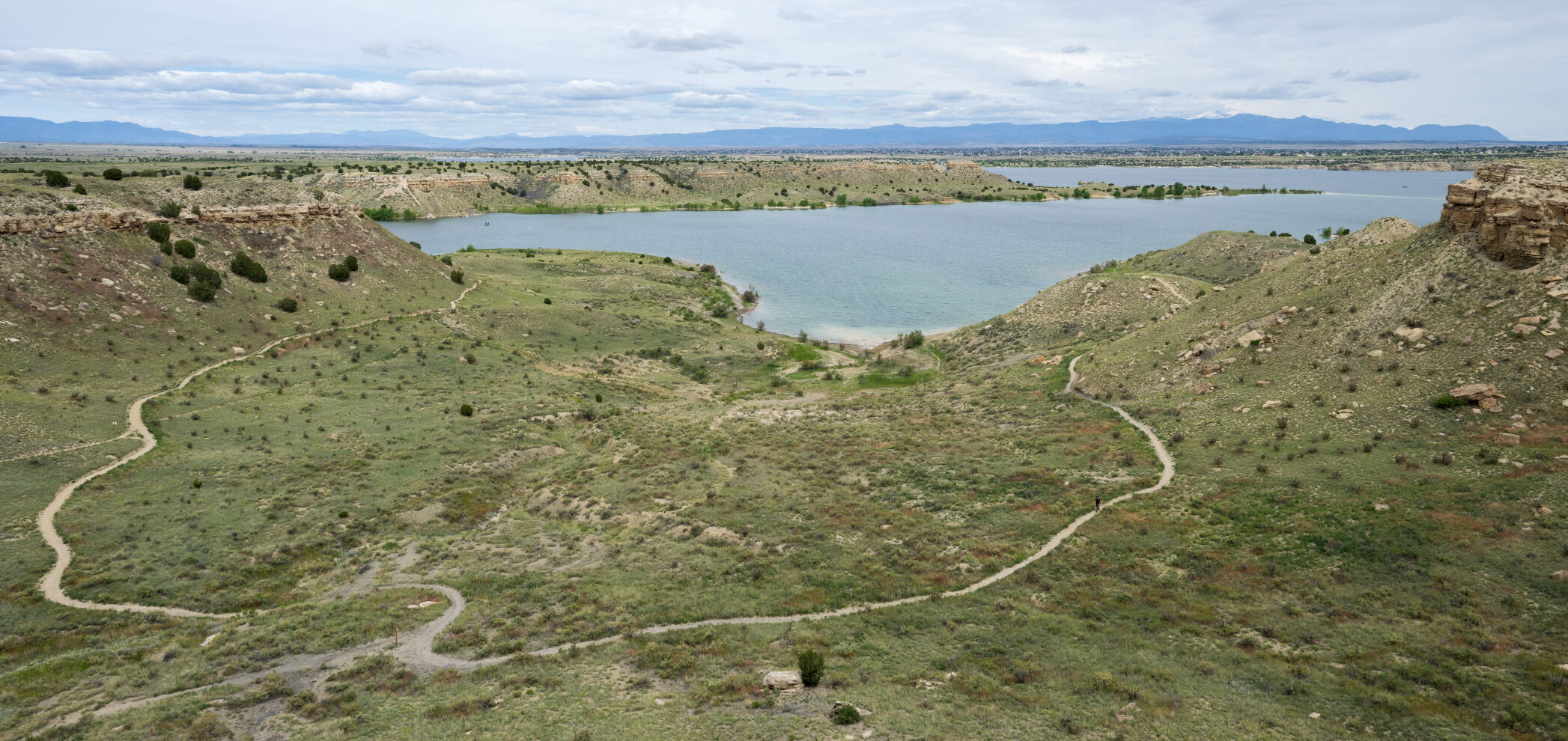A hiker makes his way along the South Shore Trail from the South Shore campground and trailhead with Bogg’s Creek Cove and Lake Pueblo in the background Tuesday, June 4, 2024. (Christian Murdock, The Gazette)