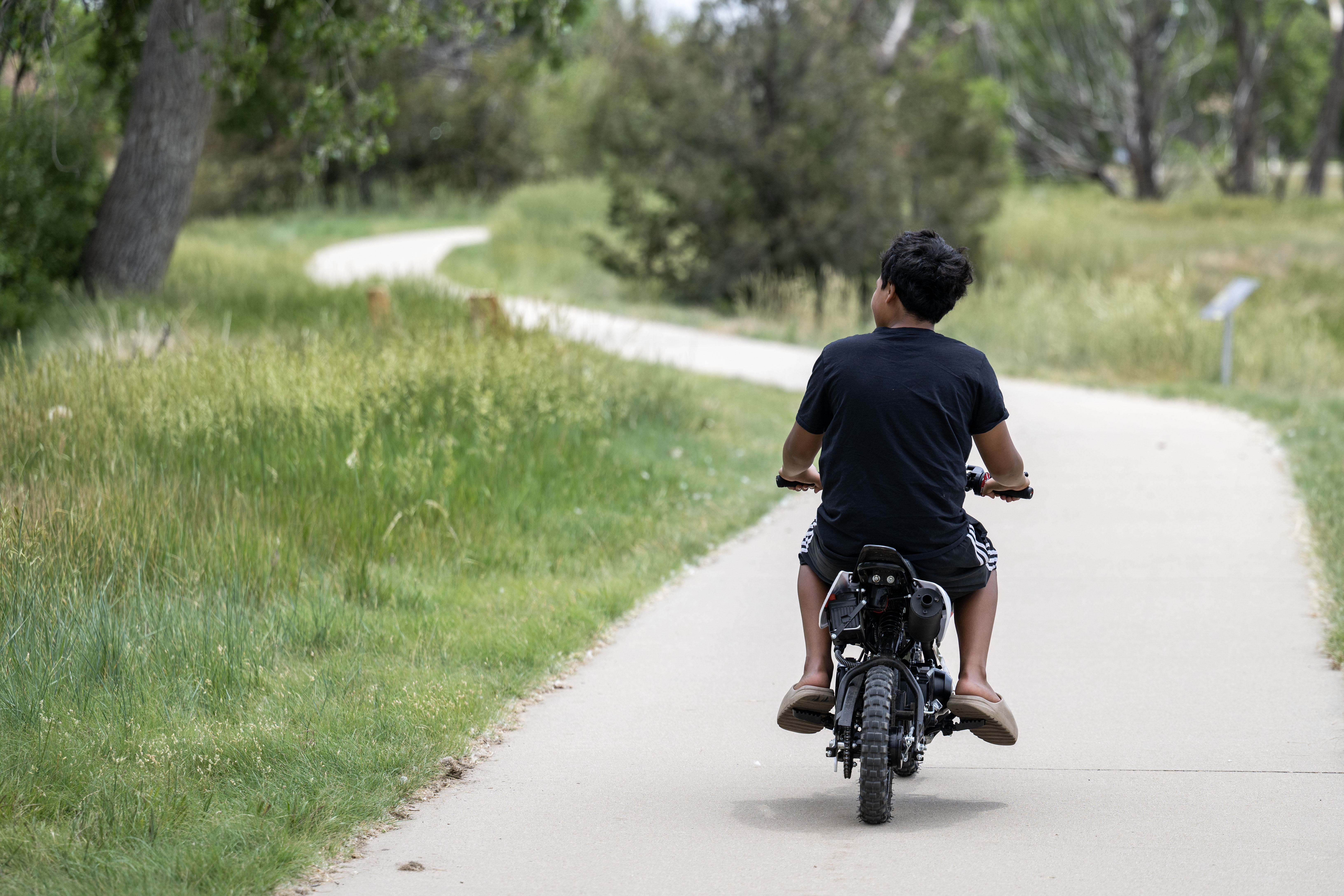 A kid rides his motorcycle along the Highline Canal on Friday, June 14, 2024. (Stephen Swofford, Denver Gazette) (StephenSwoffordPhotographerstephen.swofford@gazette.comhttps://secure.gravatar.com/avatar/1ddcaf11c5d70eaa58546ddc4e038687?d=mm&r=g)