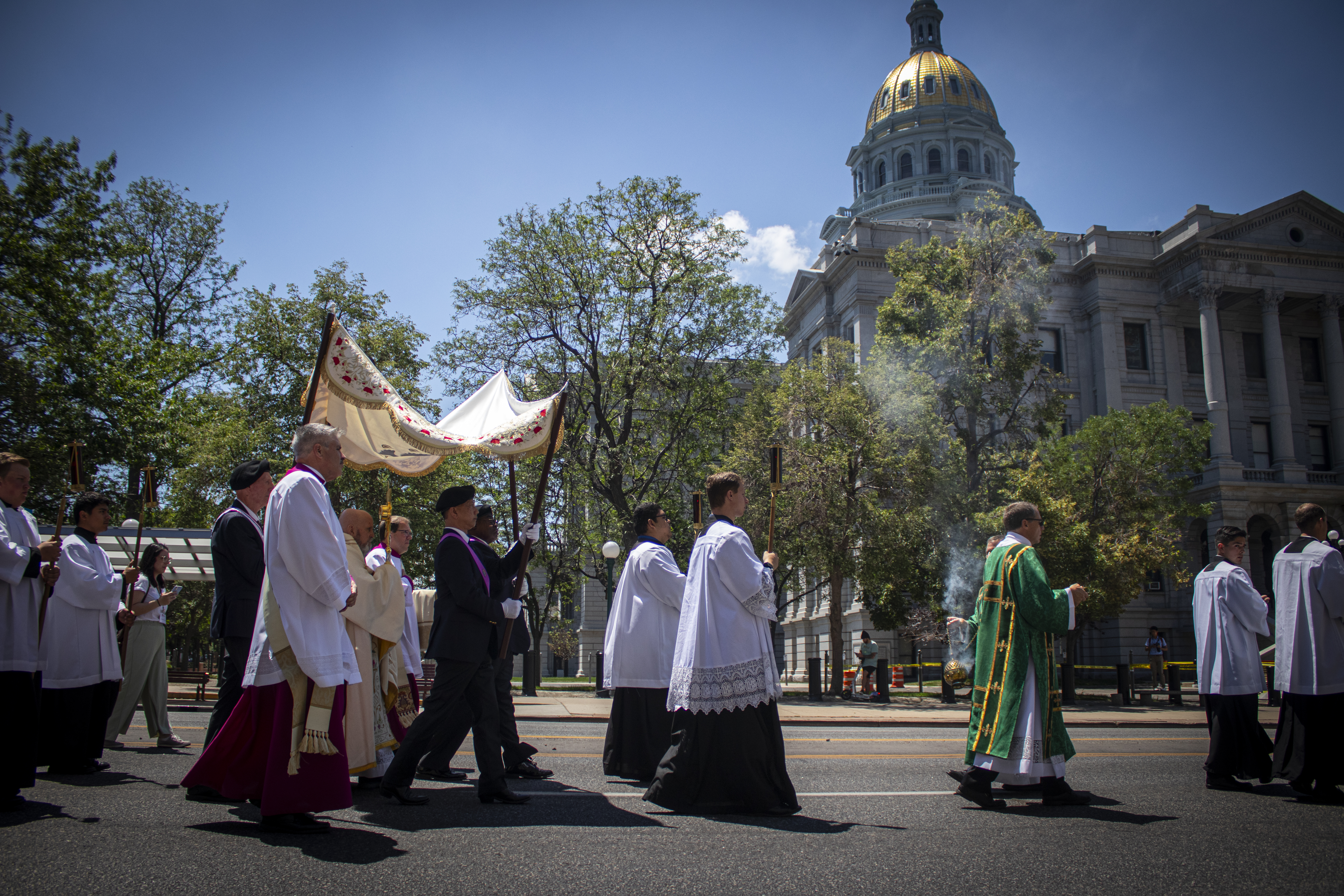 A Eucharistic procession, part of a national pilgrimage journeying from San Francisco to Indianapolis, passes by Colorado's Capitol building on Sunday, June 9, 2024. Denver Archbishop Samuel Aquila said believers shouldn't identify with politics but rather with God ahead of the ceremony. (Bernadette Berdychowski / Denver Gazette)