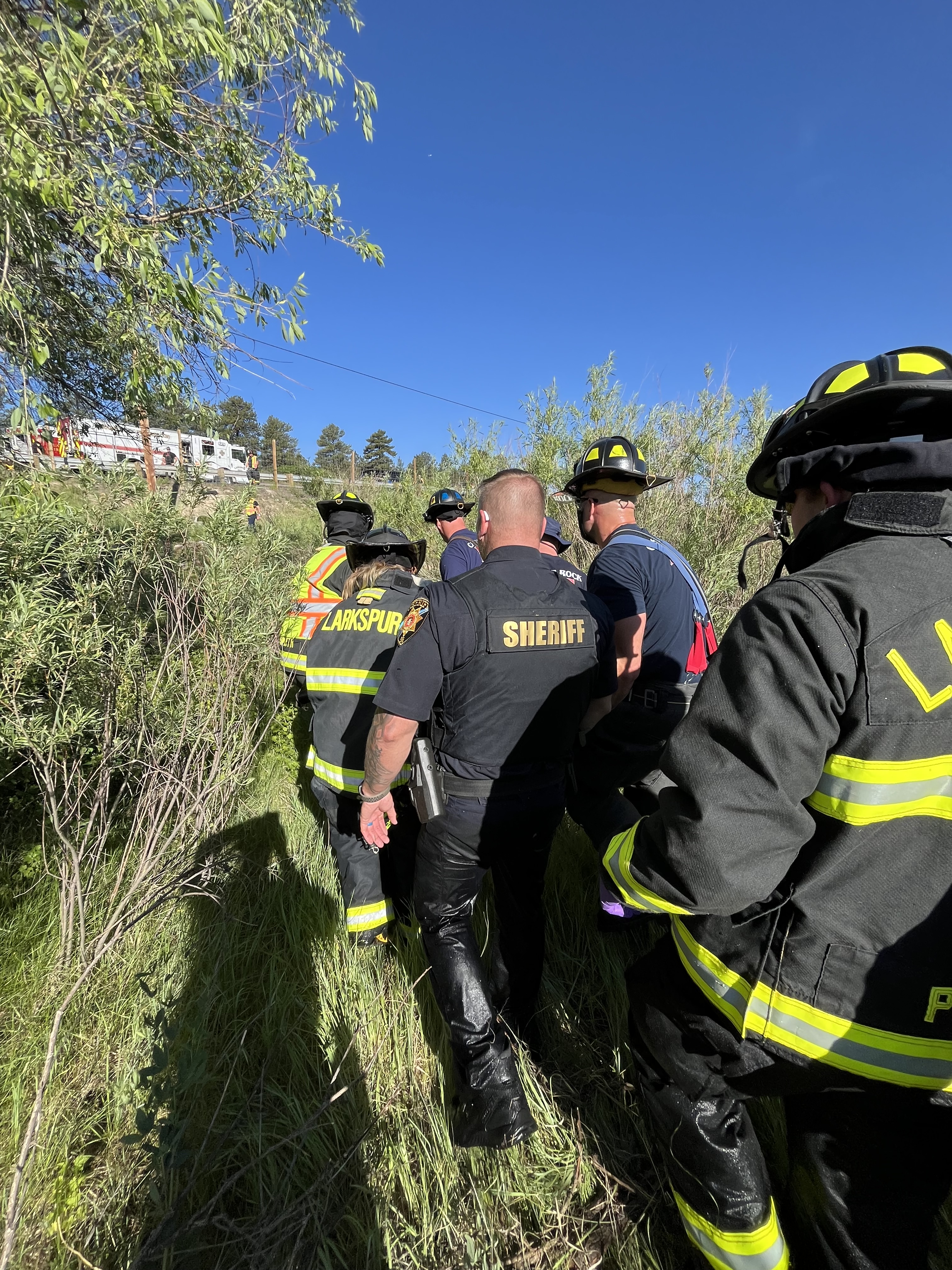 Police and fire rescue personnel assist one of two individuals aboard a small aircraft that crashed near I-25 and the Larkspur exit Sunday. (Courtesy photo, Douglas County Sheriff's Office)