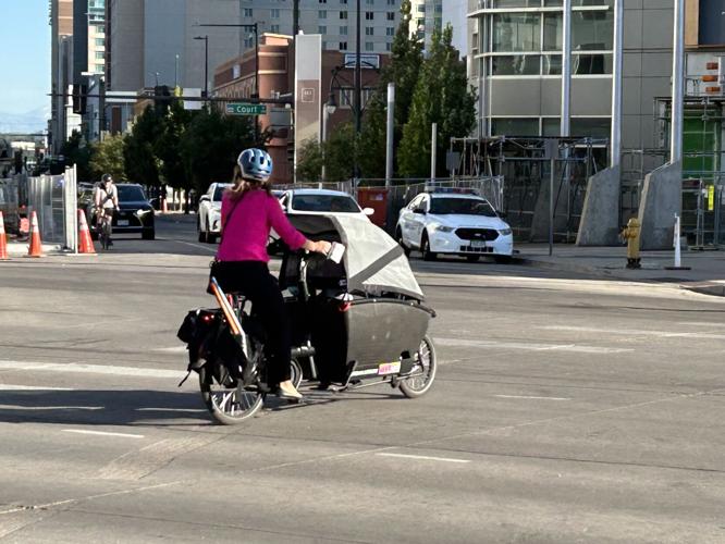 Cyclist crossing Colfax Avenue
