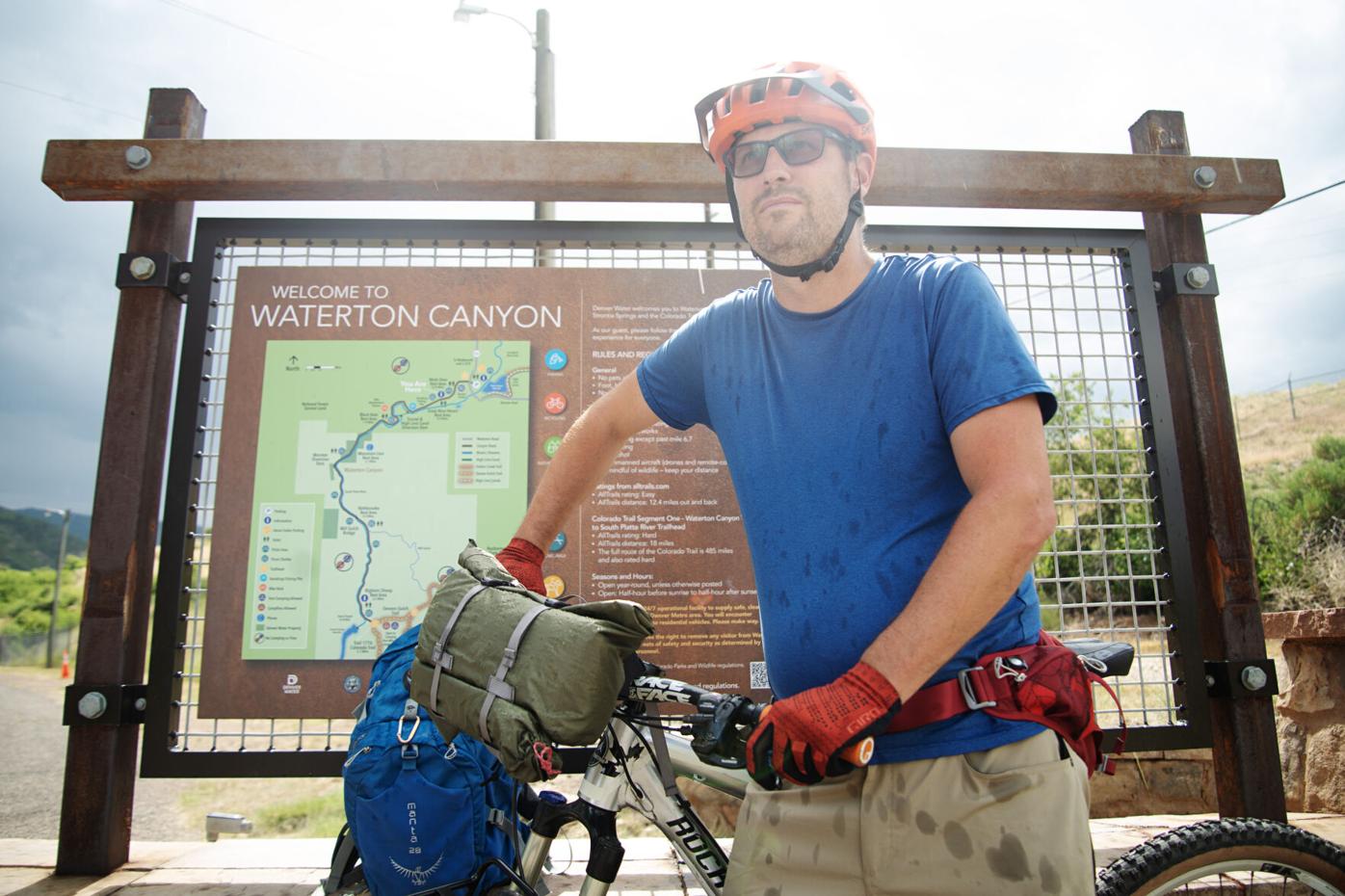Jonathan Ingraham stands with his bike at the Waterton Canyon
