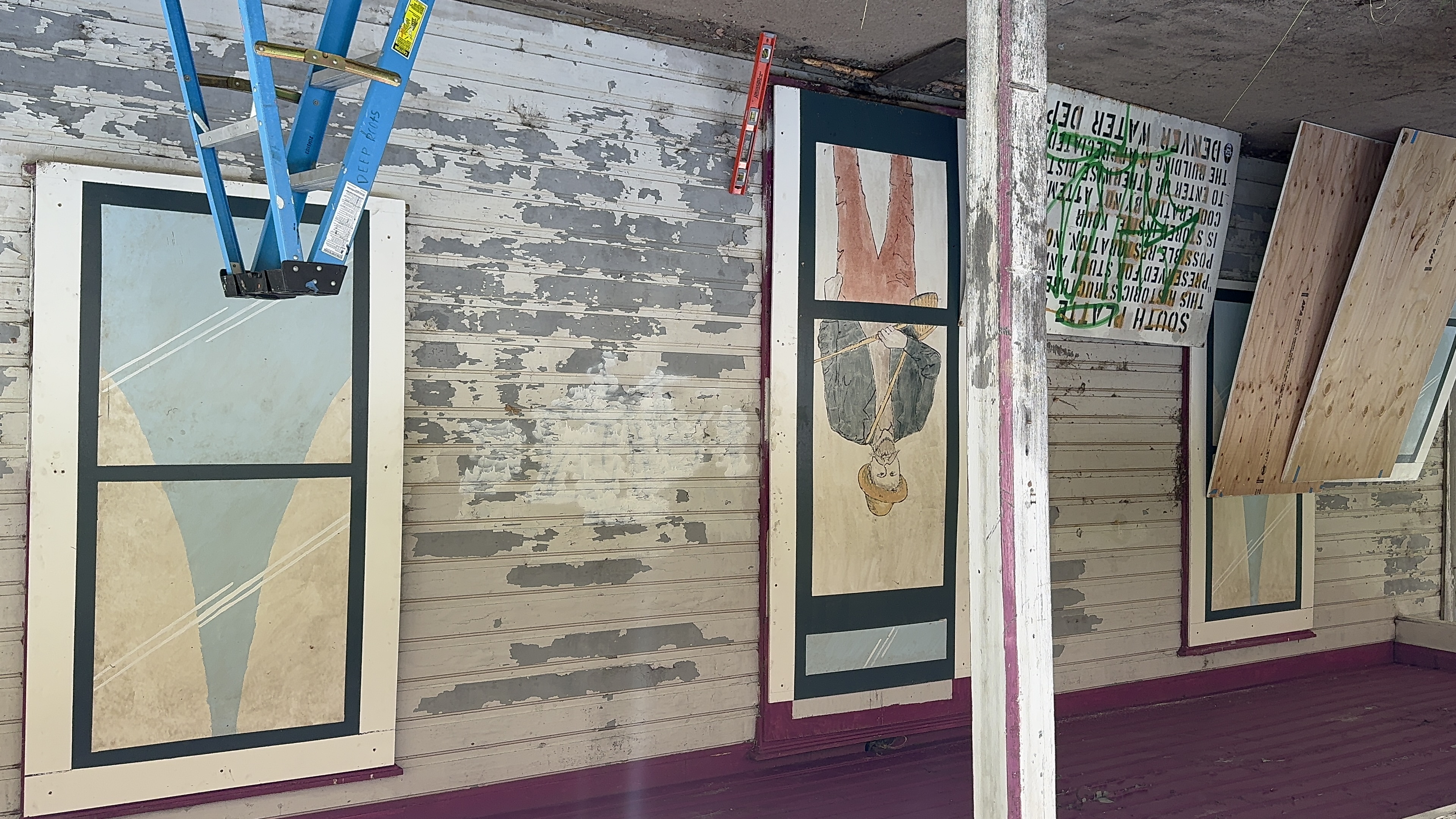 Decorative panels depicting what life may have been like at the historic South Platte Hotel help deter vandals, animals and the sometimes brutal Colorado elements. The project, sponsored by Colorado preservation, Inc. hopes to engage interest and public conversation about the fate of the 111-year-old structure. (Courtesy photo, Colorado Preservation, Inc.)