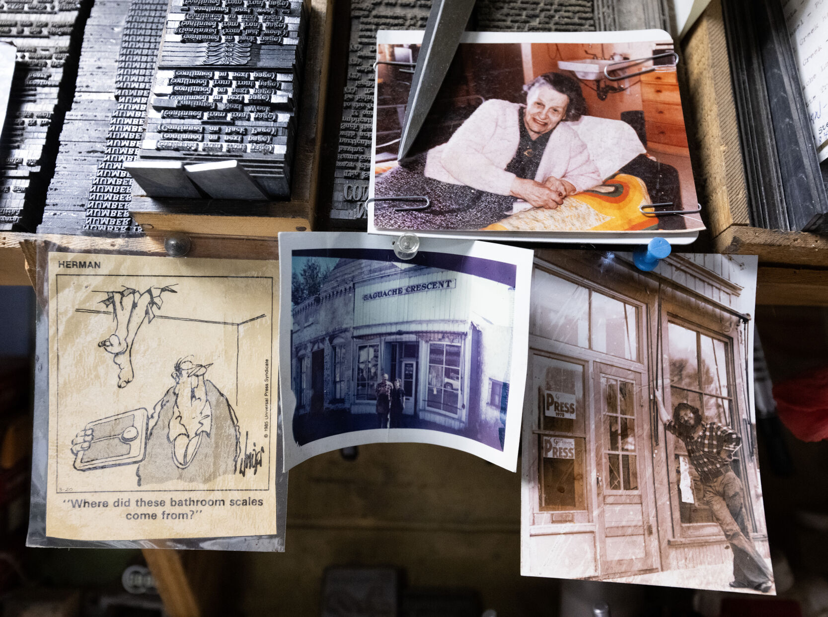 Pictures of Dean Coombs in the late 1970s or early 1980s, his parents, Marie and Ivan, and his grandmother are pinned to shelves of blocks of lead words in the backshop of the Saguache Crescent Thursday, May 8, 2024, in Saguache, Colo. (The Gazette, Christian Murdock) (Christian Murdock/The Gazette)