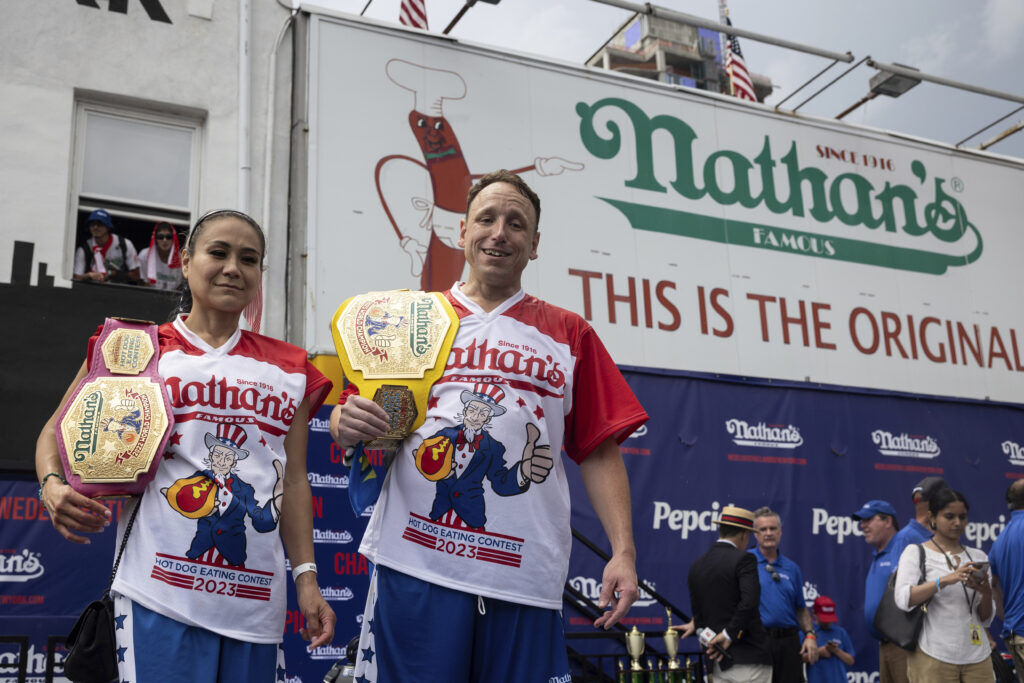 This year's woman's champion Miki Sudo, left, and man's champion Joey Chestnut, right, stand together during the 2023 Nathan's Famous Fourth of July hot dog eating contest in the Coney Island section of the Brooklyn borough of New York, Tuesday, July. 4, 2023. (AP Photo/Yuki Iwamura) (Yuki Iwamura)