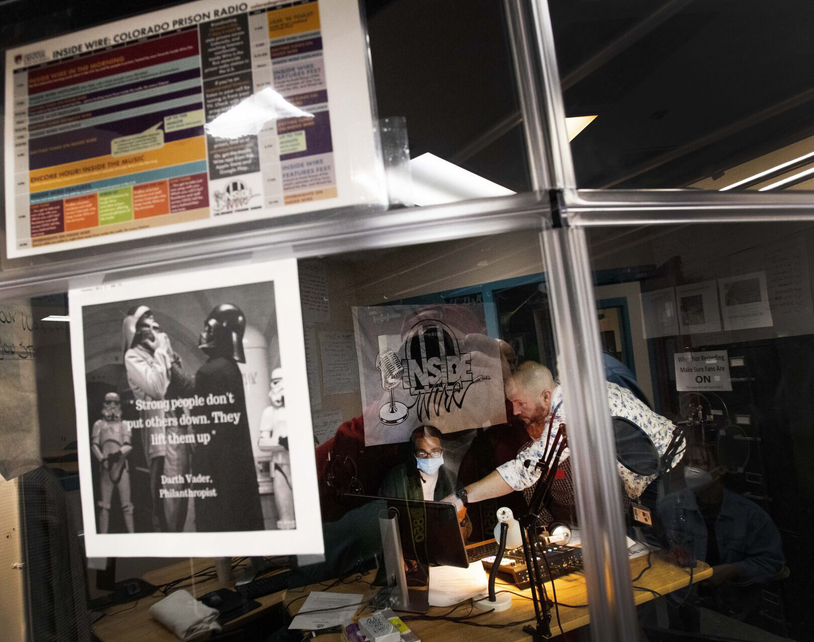 General manager and program director Ryan Conarro, right, helps music director Darius Turner prepare Inside Wire: Colorado Prison Radio to go online in March 2022 from the Limon Correctional Facility. (Christian Murdock, the gazette file)