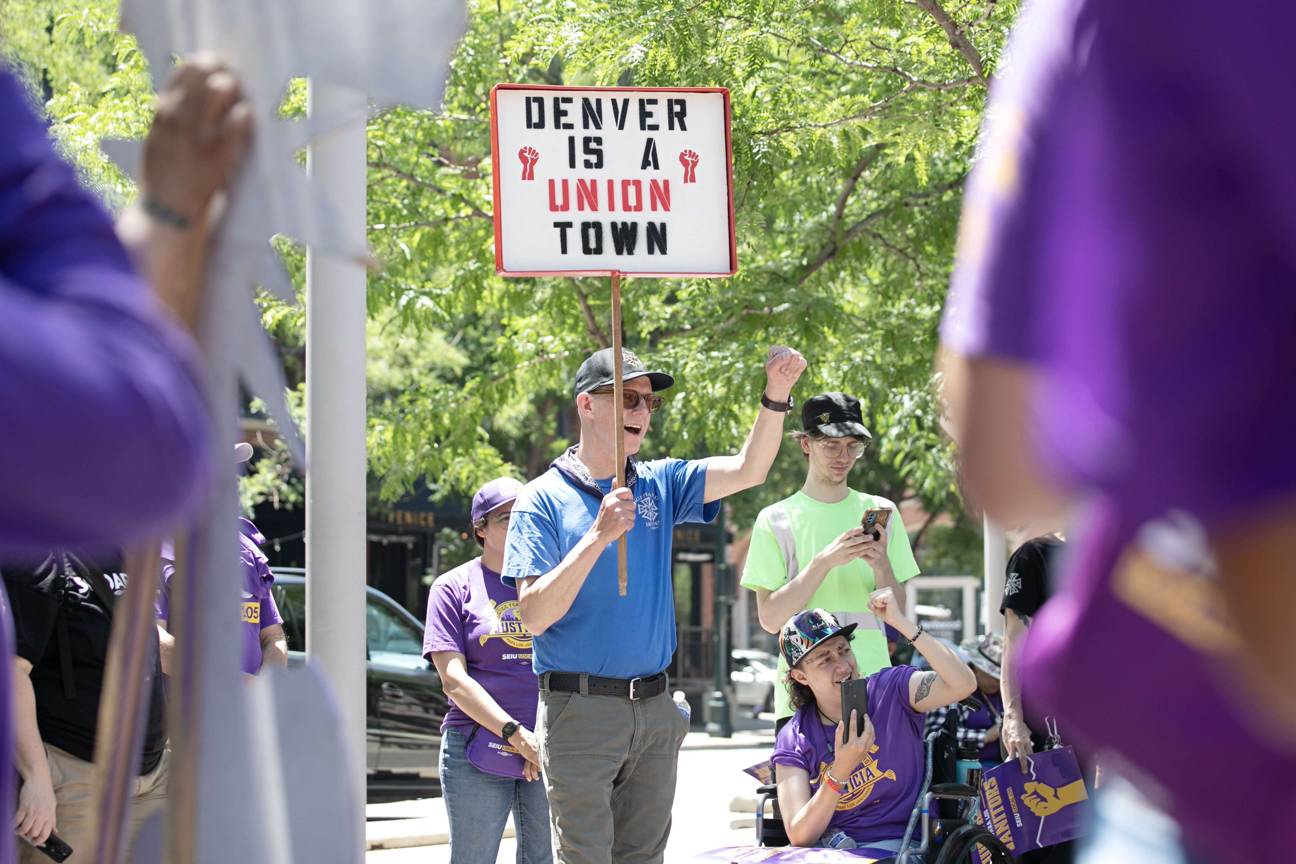 Keven Soll chants with members of the Service Employees International Union (SEIU) Local 105 during a 