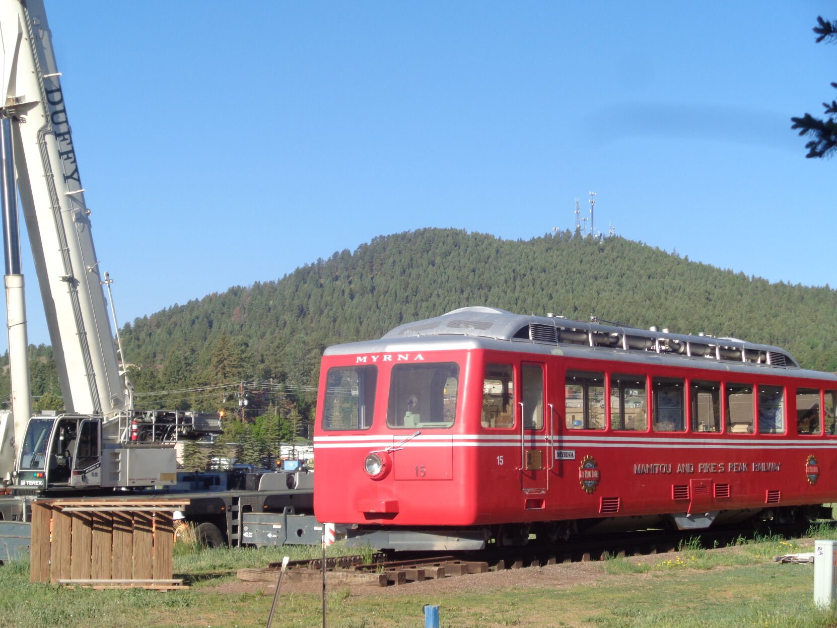 In the early morning hours of June 12, the Tava Group prepares the preliminaries to have Duffy’s Crane move the Cog railway car from Woodland Station to the Centennial Trailhead. (Pat Hill, Pikes Peak Courier)