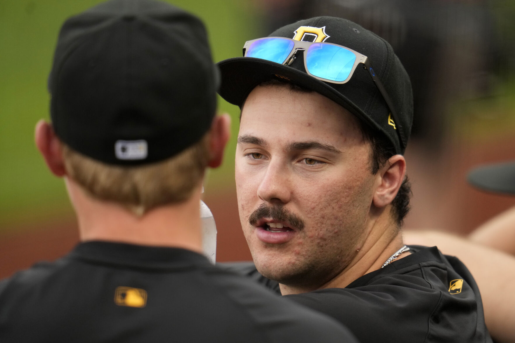 Pittsburgh Pirates pitcher Paul Skenes, right, talks with pitcher Mitch Keller in the dugout during a game against the Los Angeles Dodgers in Pittsburgh on June 4. (the associated press)