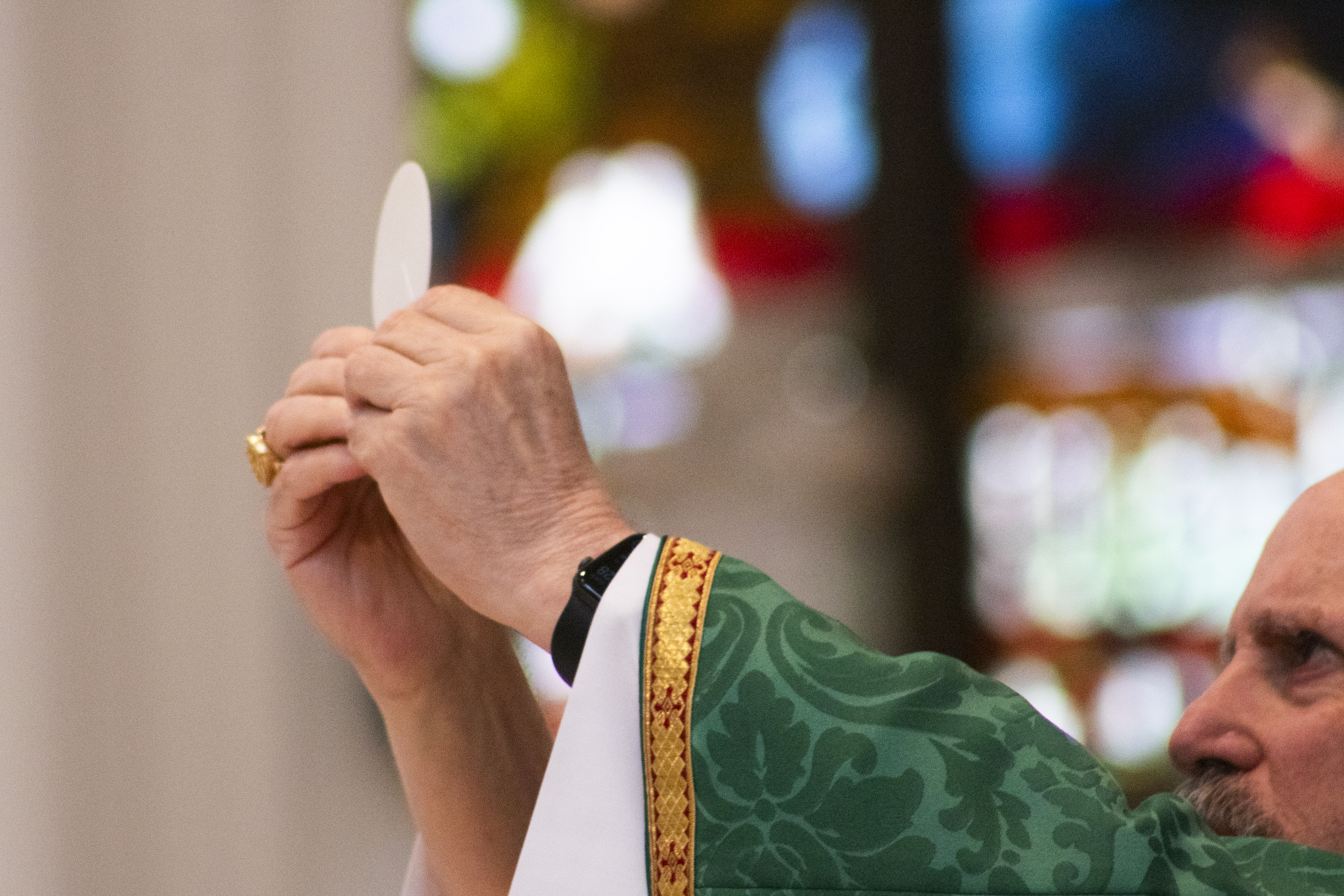 Denver's Archbishop Samuel Aquila raises a host of bread — which Catholics believe is the body of Christ — at the Cathedral Basilica of the Immaculate Conception in downtown Denver on Sunday, June 9, 2024. The Mass was part of a national pilgrimage meant to help revive belief of the church's theology on Holy Communion. (Bernadette Berdychowski / Denver Gazette)