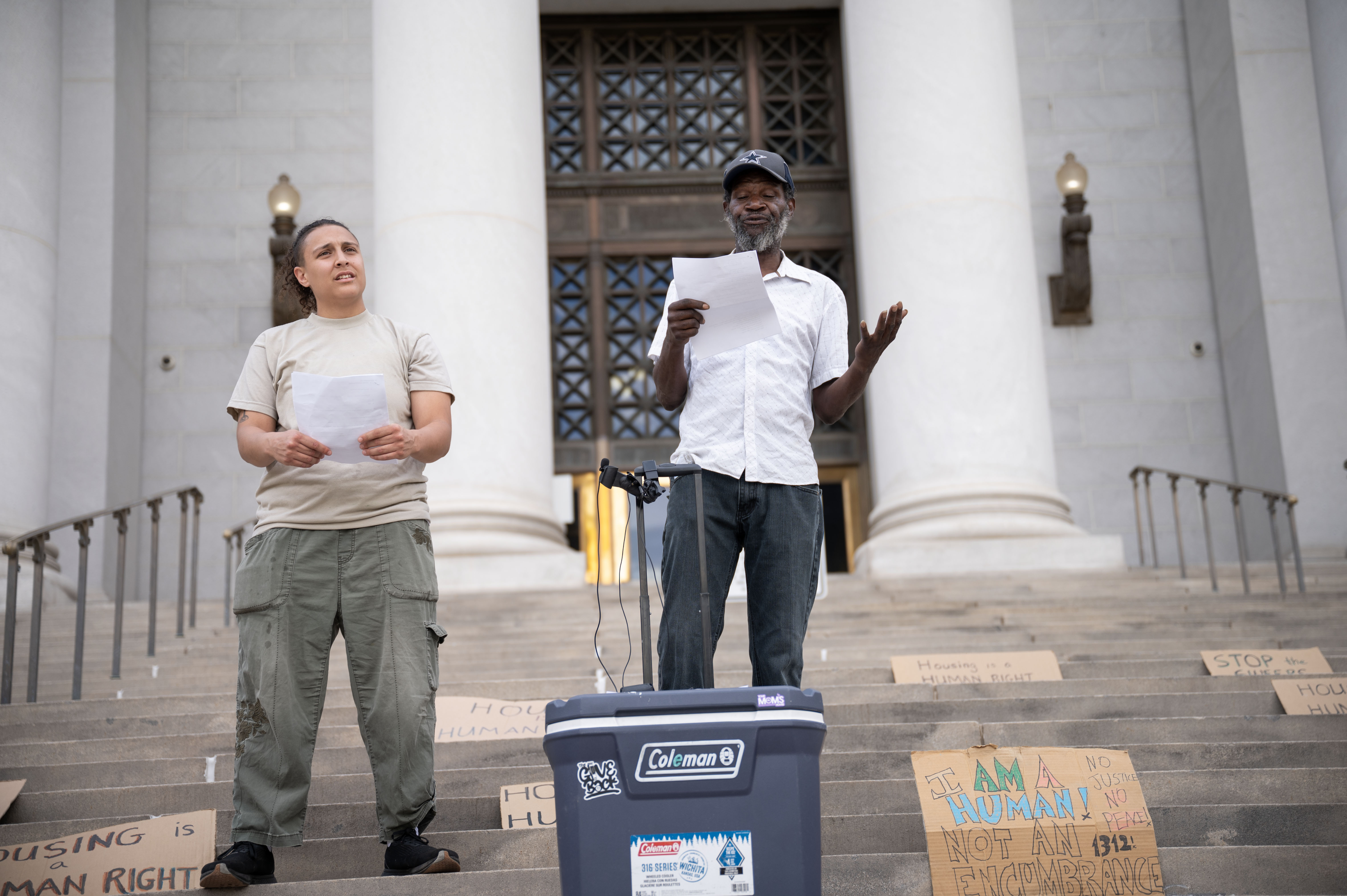 Gigi Hagopian, a member of the Housekeys Action Network Denver, left, stands with Jerry Burton as they discuss police records of anti-houseless law enforcement in Denver from January to March of 2024 during a protest on the steps of the Denver City and County Building on Monday, June 3, 2024. (Stephen Swofford, Denver Gazette) (Stephen Swofford The Gazette)
