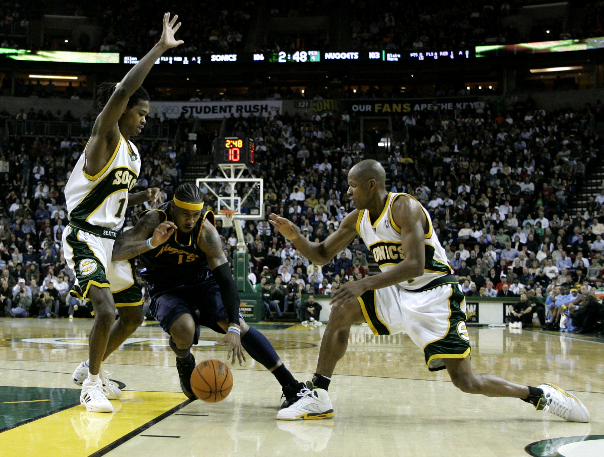 Denver Nuggets' Carmelo Anthony drives between Seattle SuperSonics' Mickael Gelabale, left, of France, and Sonics' Ray Allen in the fourth quarter of an NBA basketball game Tuesday, Jan. 23, 2007 at KeyArena in Seattle. The Nuggets beat the Sonics 117-112. (AP Photo/Ted S. Warren) (Ted S. Warren)