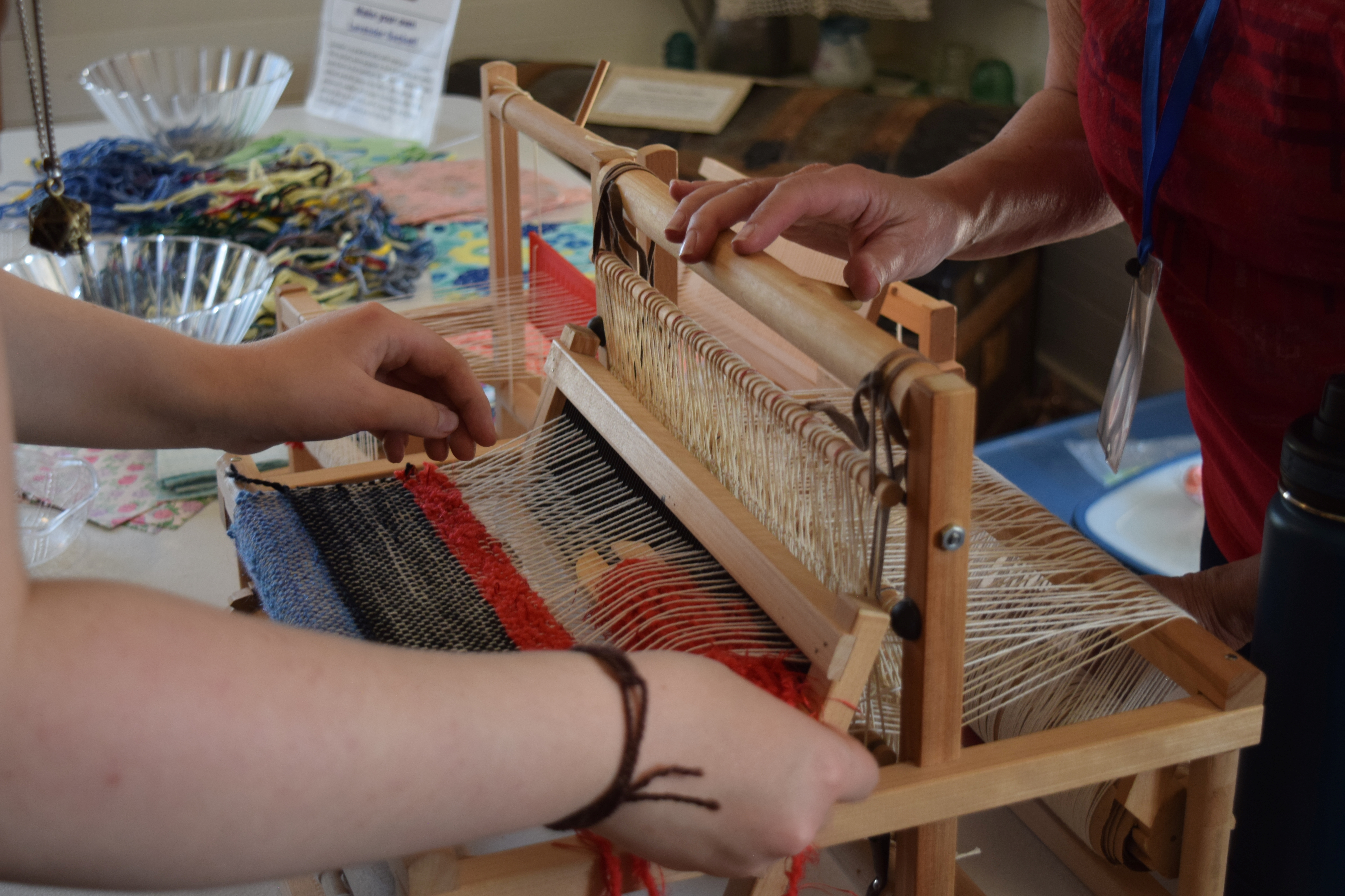 17 Mile House volunteer, Suzette Flashel, shows an attendee how to use the small weaving loom during the park's wool spinning open house on Saturday.The open house showed the entire clothes-making process from the 1800s, demonstrating wool spinning, carding, dying and weaving. (SageKelleyJefferson County Reportersage.kelley@denvergazette.comhttps://denvergazette.com/content/tncms/avatars/e/5f/457/e5f45740-2717-11ee-85b2-ab80f2d36252.5b966c1d2ce4987987665d57c237eda4.png)