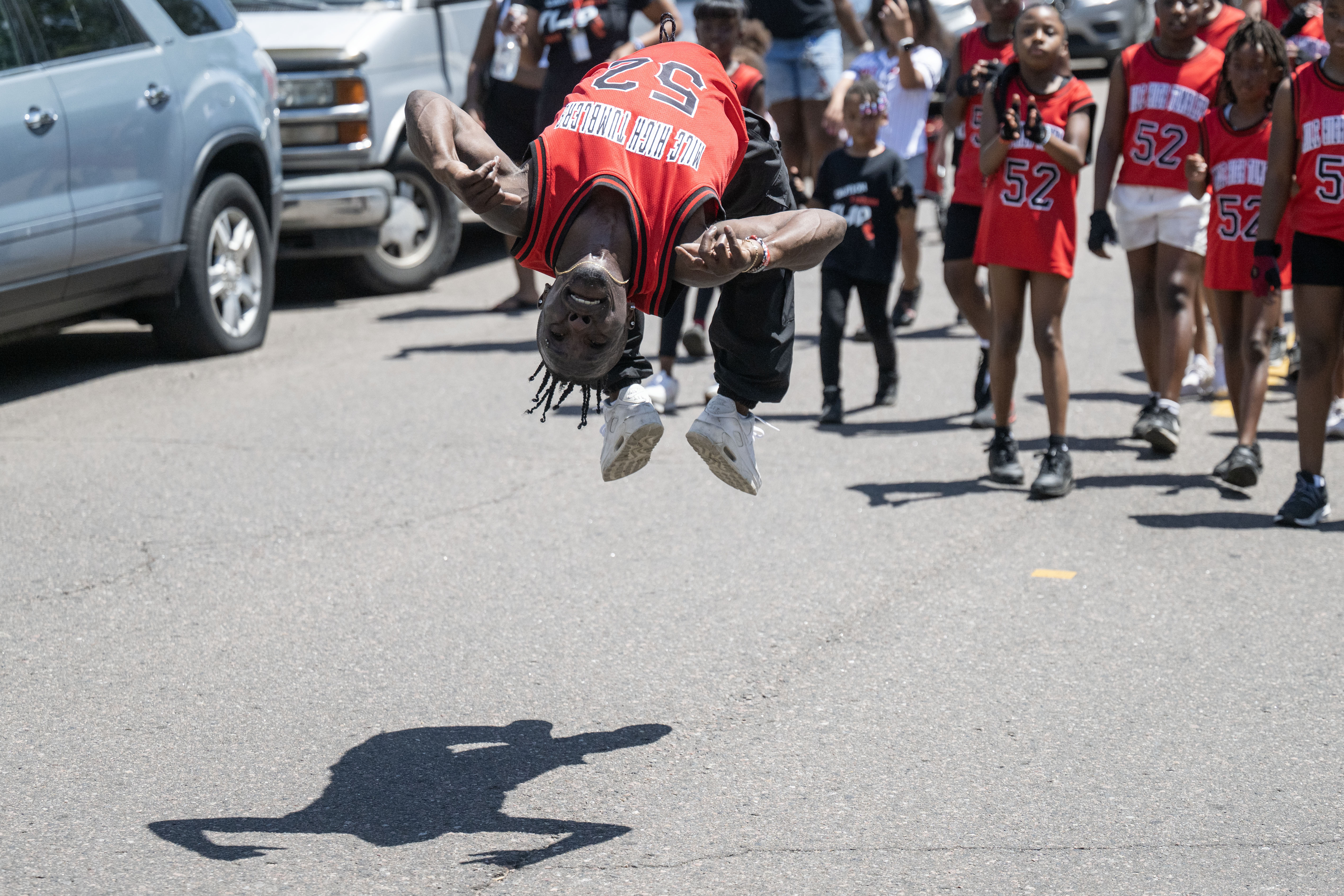 Coach Ozell Williams, from Mile High Tumblers 5280, does a series of backflips down 26th avenue during the Juneteenth parade in Denver on Saturday, June 15, 2024. (Stephen Swofford, Denver Gazette) (Stephen Swofford The Gazette)