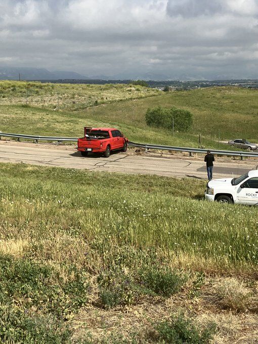 A red pickup rests against a guard rail along the perimeter road at Rocky Mountain Metropolitan Airport in Broomfield, Colorado. The vehicle blew through a security gate, went down an embankment an came to rest along the railing. The driver of the vehicle was taken to a local hospital for treatment. (Jefferson County Sheriff)