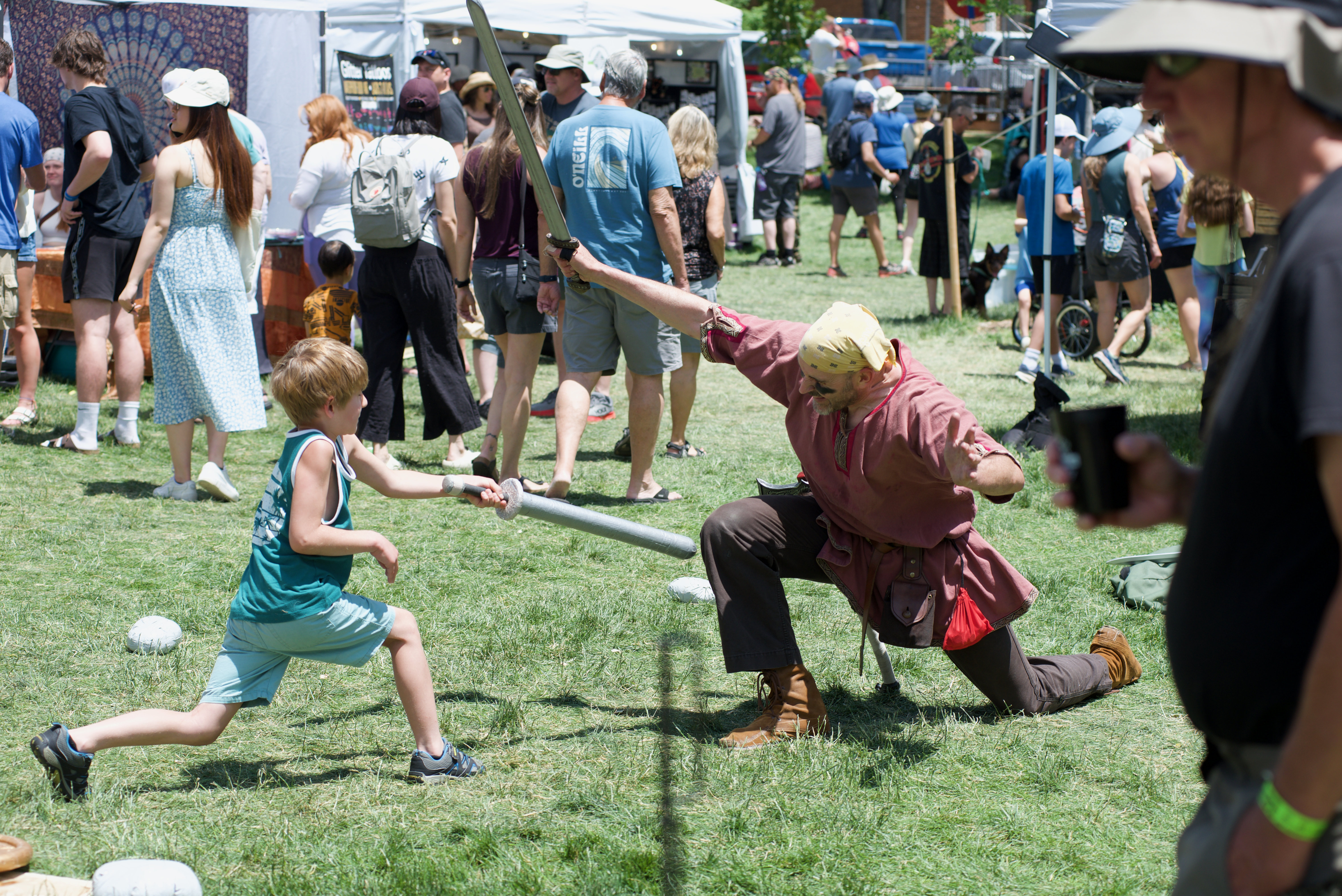 Jude Vickroy play fighting against a Viking teacher on June 17, 2024. The seven year old said he had tremendous fun in his ultimately successful duel. (AlexanderEdwardsBusiness Reporteralex.edwards@gazette.comhttps://secure.gravatar.com/avatar/dbaa50cc8a9183e280c297e3afa72ace?d=mm&r=g)