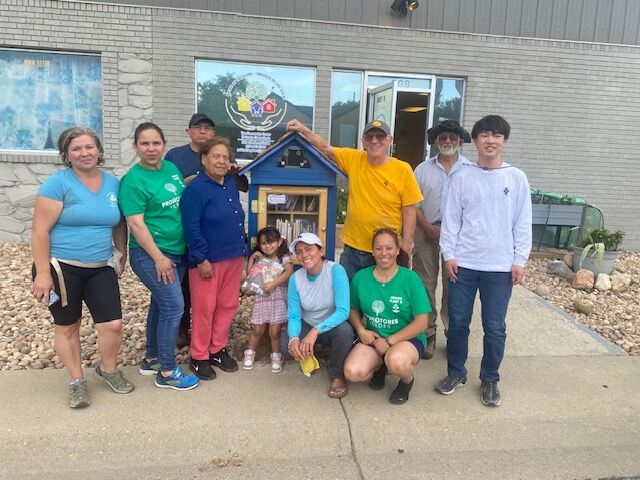 A Little Free Library full of books stands in front of the Pride of the Glens - Orgullo de los Glens - thanks to volunteers. The project is private and required no city permits. Russ Schnell and Lupita Cardoza hope that the