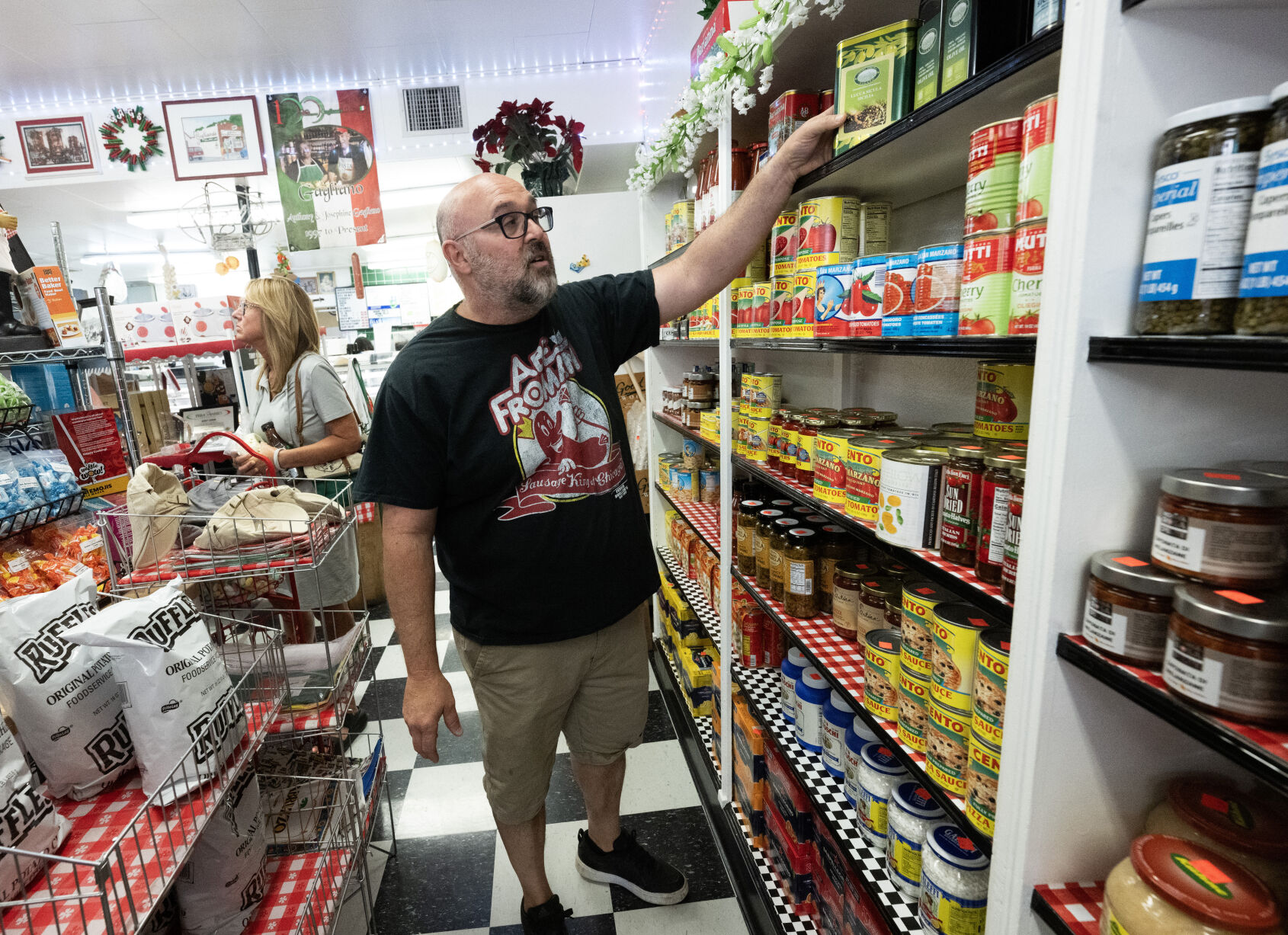 Vince Gagliano pulls some of the olive oil this month from his mother’s family farm in Italy that they sell at Gagliano’s Italian Market & Deli in Pueblo. (Christian Murdock, The Gazette)