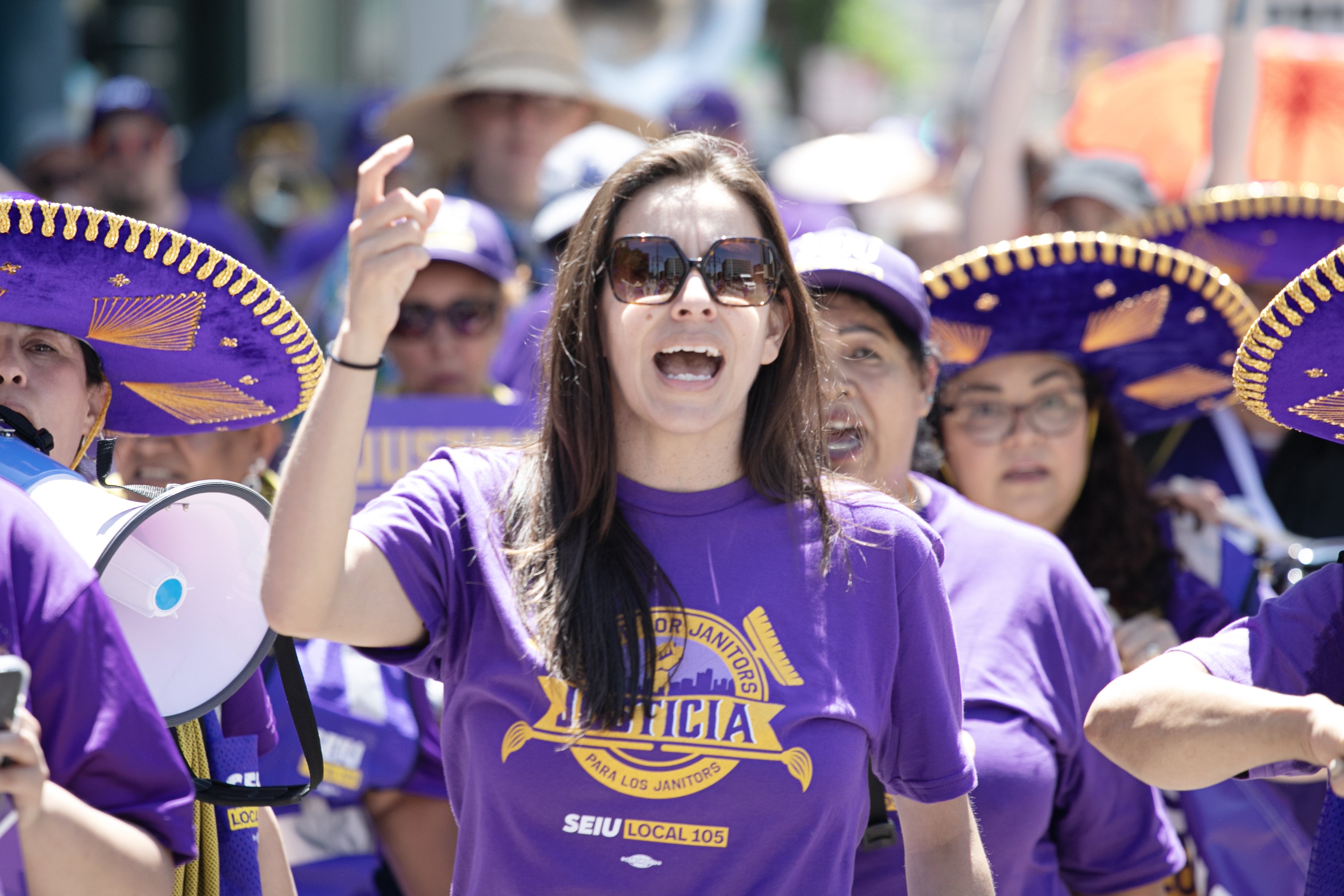 Stephanie Felix-Sowy, president of the Service Employees International Union (SEIU) Local 105, chants with other members during a 