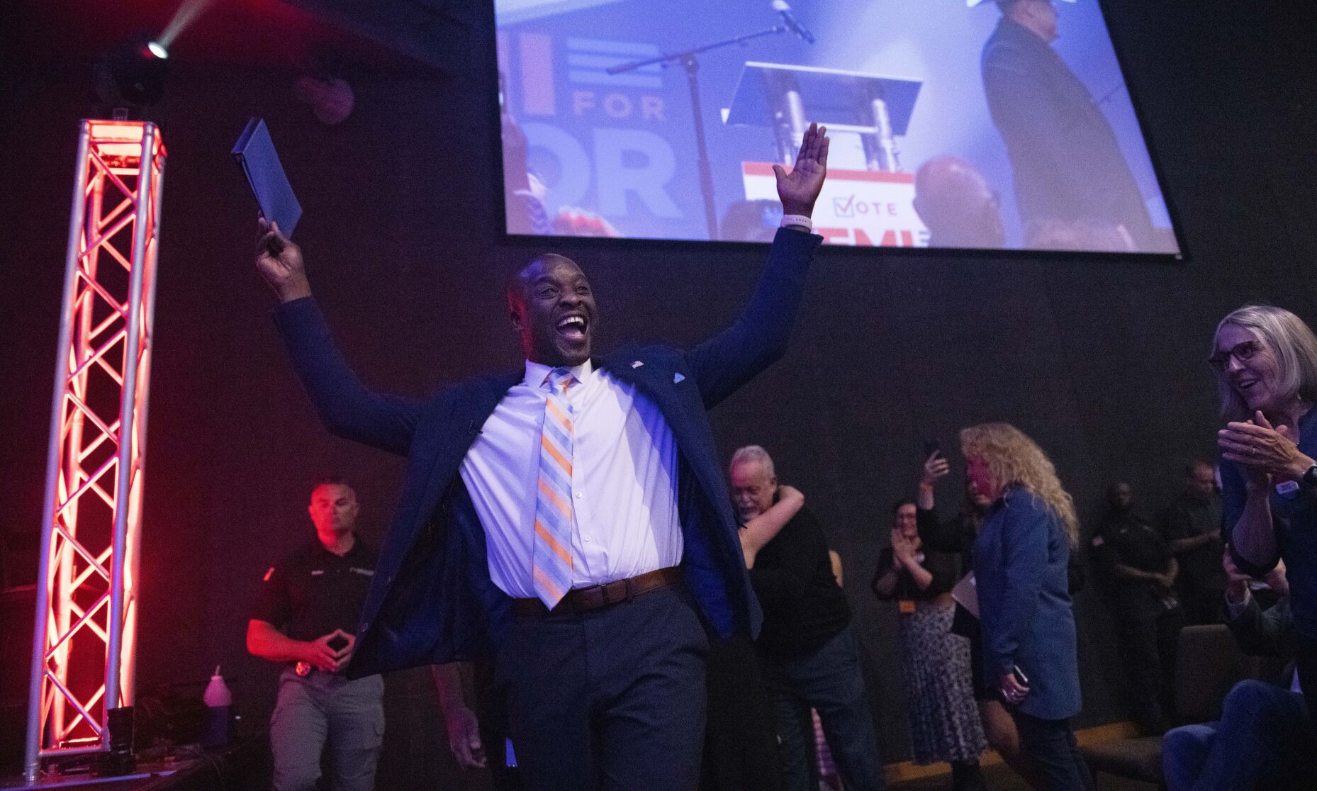 Yemi Mobolade cheers as he runs onto the stage to give his victory speech on May 16, 2023, during an election watch party at the COS City Hub in Colorado Springs. (Christian Murdock, Gazette file)