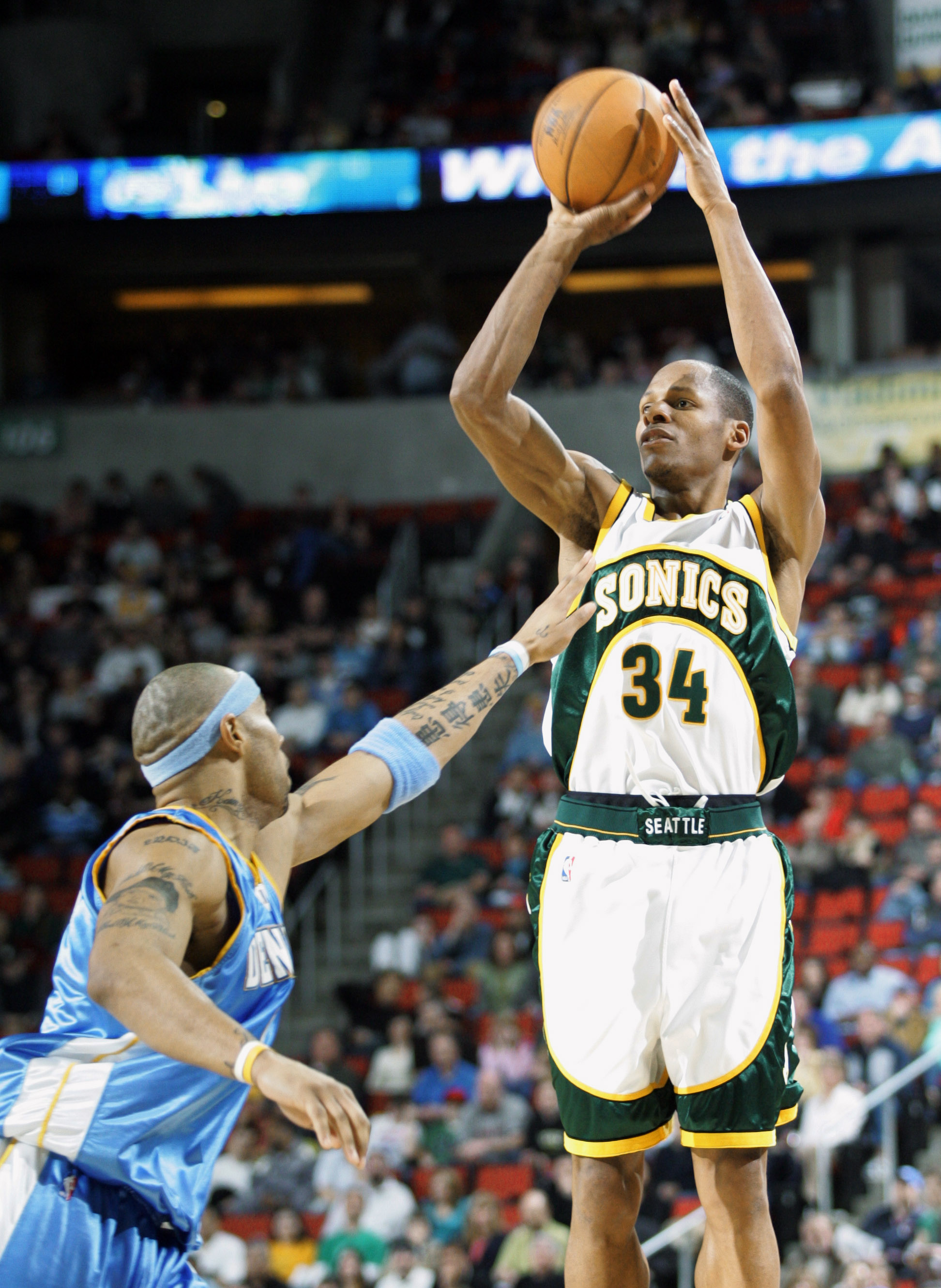 Seattle SuperSonics' Ray Allen shoots over Denver Nuggets' Kenyon Martin during the fourth quarter of an NBA basketball game in Seattle, Sunday, Feb. 12, 2006. Allen scored 34 points in the game but the Sonics lost to the Nuggets 12-112 in overtime. (AP Photo/John Froschauer) (JOHN FROSCHAUER)