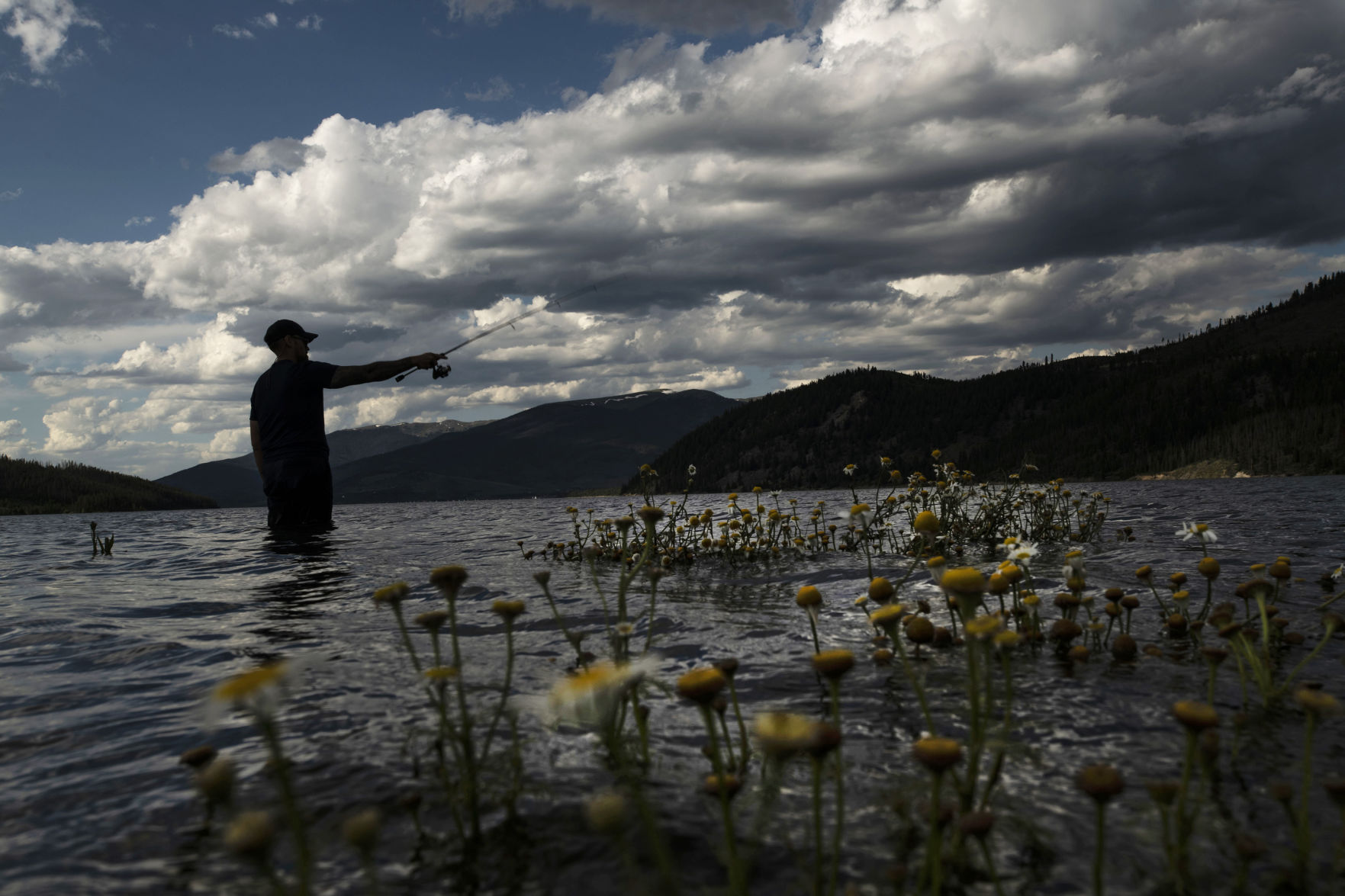 Anthony Perez wades in the water while fishing at Dillon Reservoir in Summit County on Saturday, Aug. 3, 2019. Dillon Reservoir is currently 100% full, according to Todd Hartman with Denver Water. Hartman states this time last year the reservoir was just 91% full. Dillon Reservoir was not filled until July this year, in contrast to last year which was filled at the end of May. Colorado had strong snow pack in the high country and a long run off season. “Heavy snow on both sides of the Continental Divide also means Denver Water could rely on its Front Range supplies and has not yet needed to move any water from Dillon through the Roberts Tunnel into the South Platte River system,” said Hartman. Many factors play into maintaining manageable water levels in the reservoir. “Ranging from keeping outflows from Dillon into the Blue River at manageable levels to maintaining water levels that allow for optimal recreation,” Hartman said. (CHANCEY BUSH/THE GAZETTE)