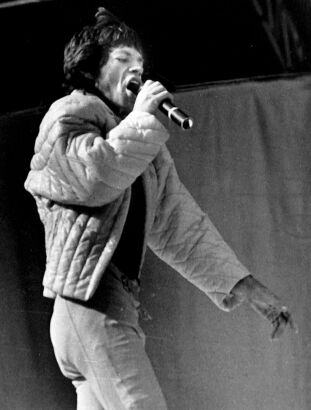 The Rolling Stones' Mick Jagger struts his stuff in Boulder wearing a yellow quilted jacket and football trousers in October 1981. From the Denver Public Library's Rocky Mountain News Collection. (Ian Campbell. courtesy Denver Public Library)
