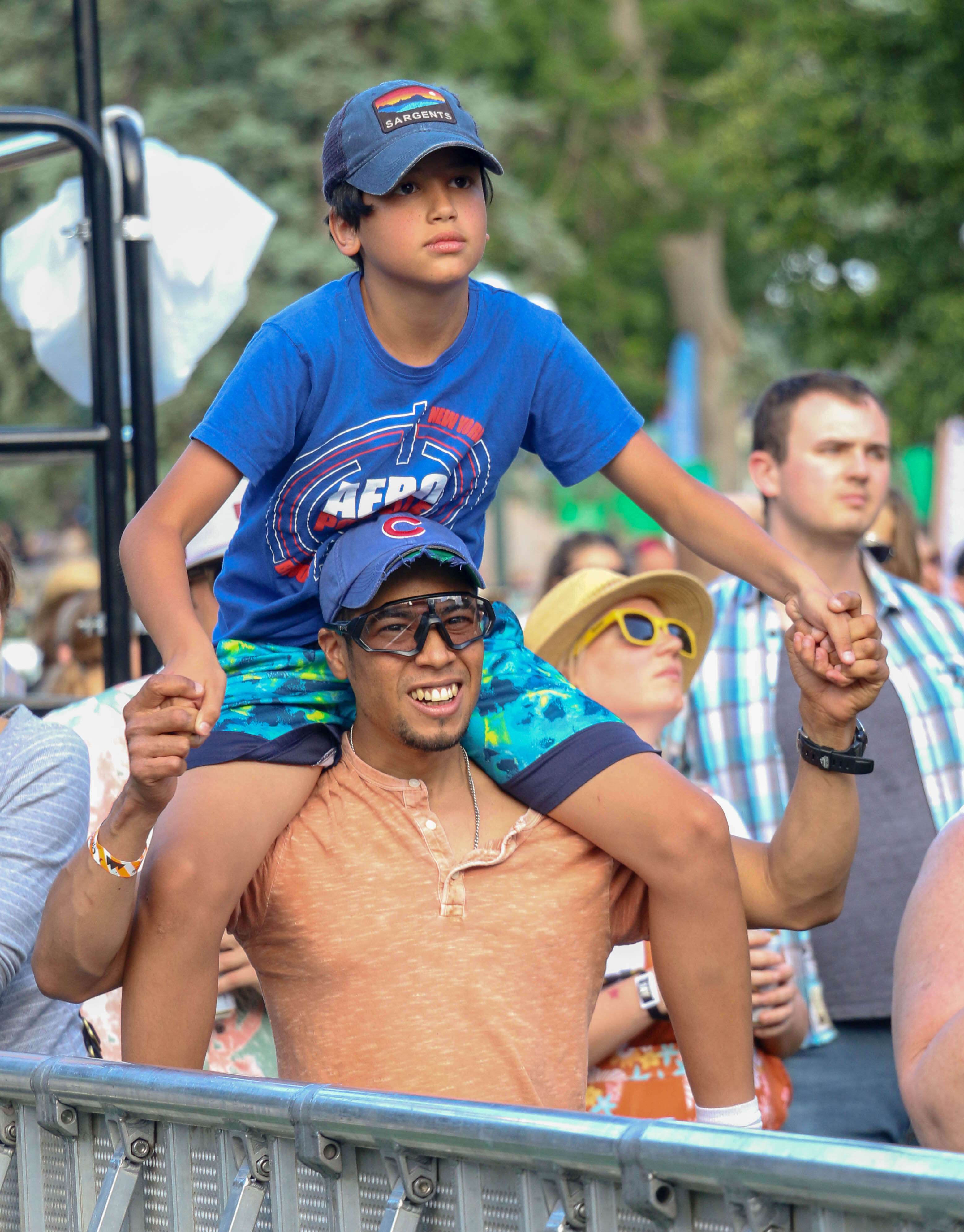 A father and son enjoy Say She She in Civic Center Park at the inaugural Outside Festival on Saturday, June 1, 2024. (John Moore)