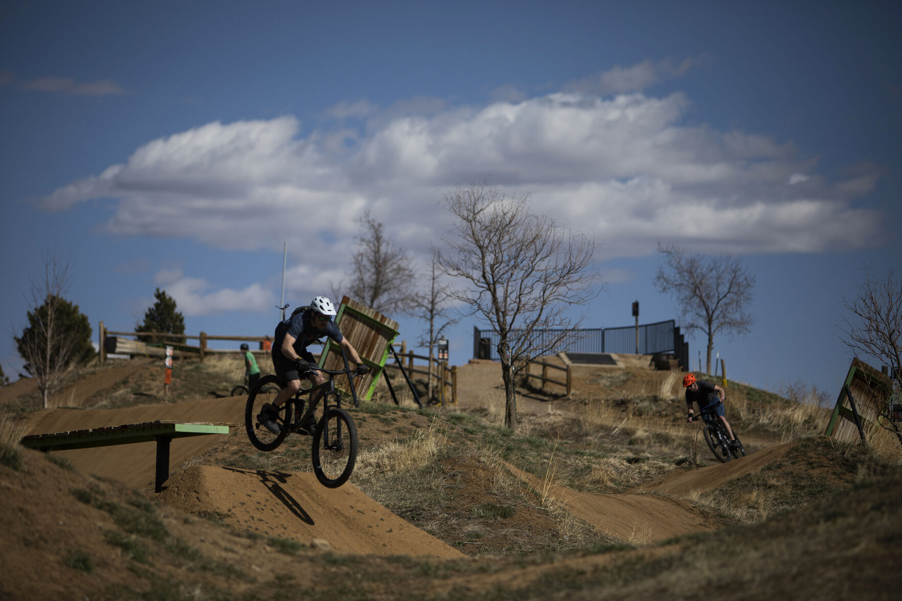 University of Colorado-Boulder student Kevin Keleher, front, jumps off an obstacle while friend Alec Shelton, right, follows at Valmont Bike Park last month in Boulder. (Timothy Hurst, The Gazette)