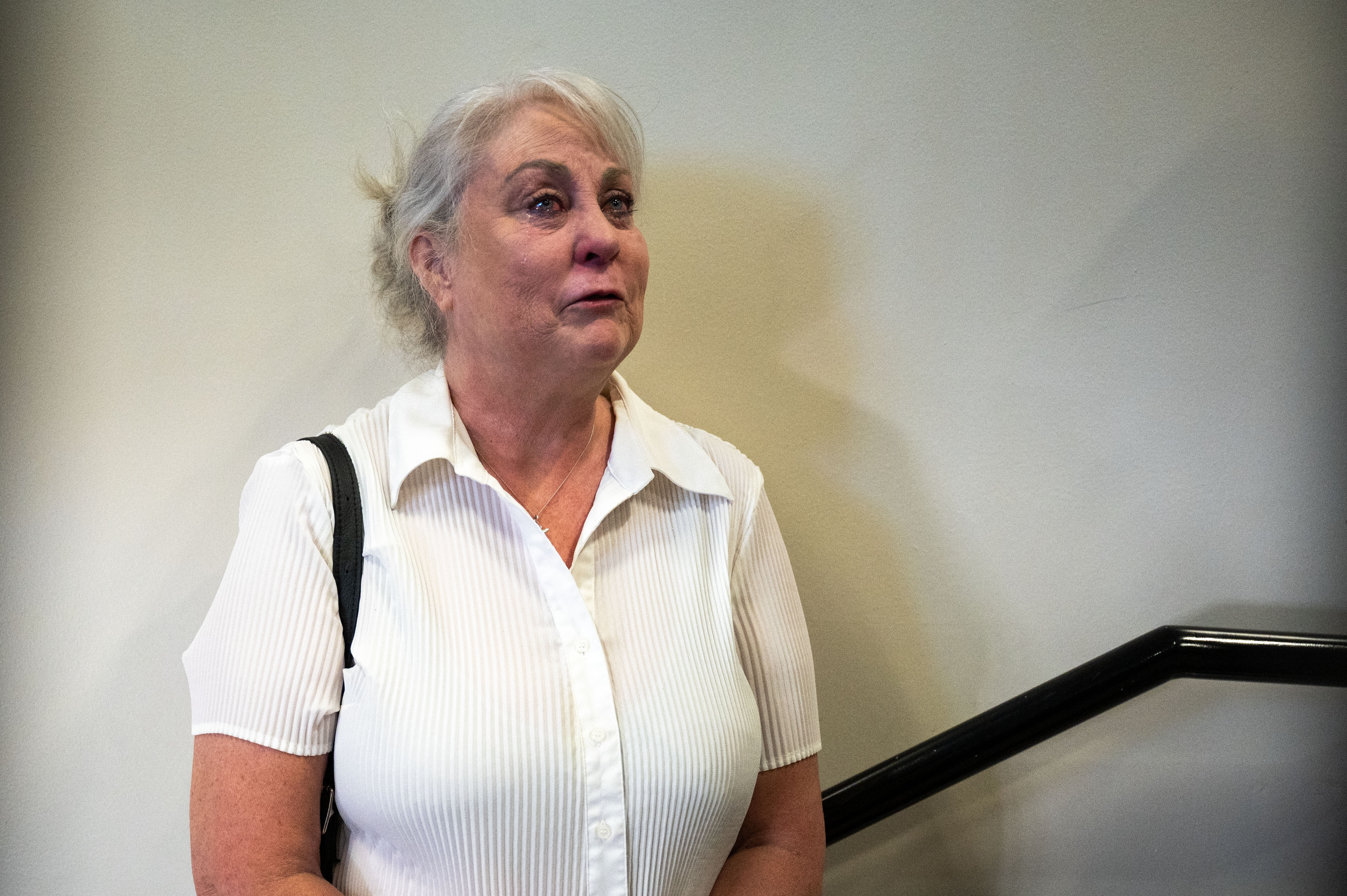 Tamara Coughlin, Stepmom of Garrett Coughlin, cries as she talks with reporters outside the courtroom after Garrett Coughlin pleaded guilty to second-degree murder for a triple homicide. Coughlin was sentenced to 42 years with the possibility of parole after 24 years. (Stephen Swofford, The Gazette)